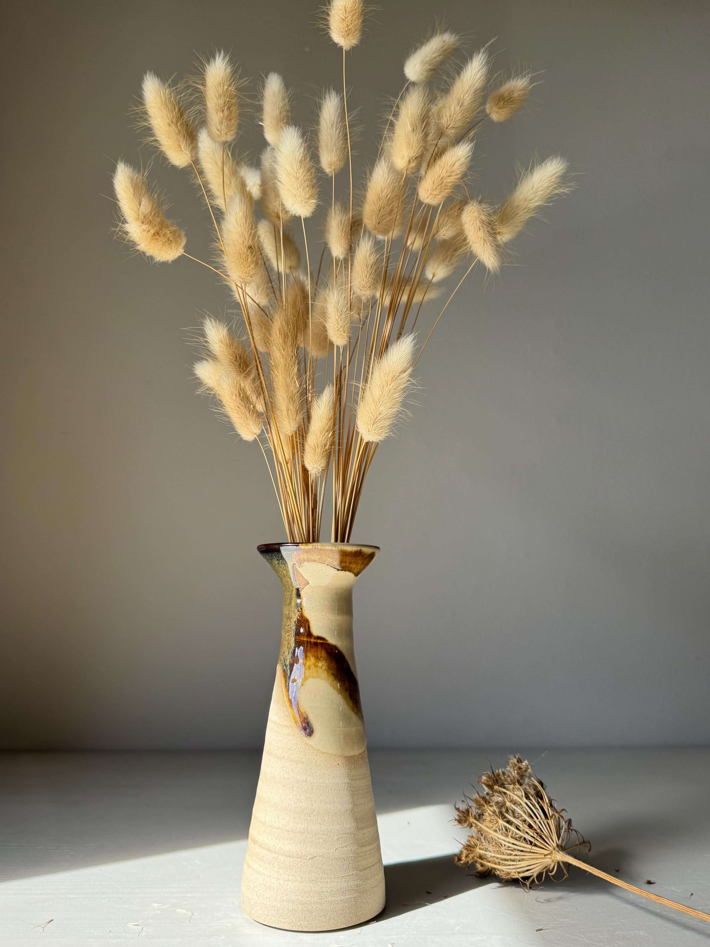 Medium Vase – Inyo Series #04 handmade ceramic tall vase with unique glaze, featuring a sculptural silhouette and dried floral arrangement.
