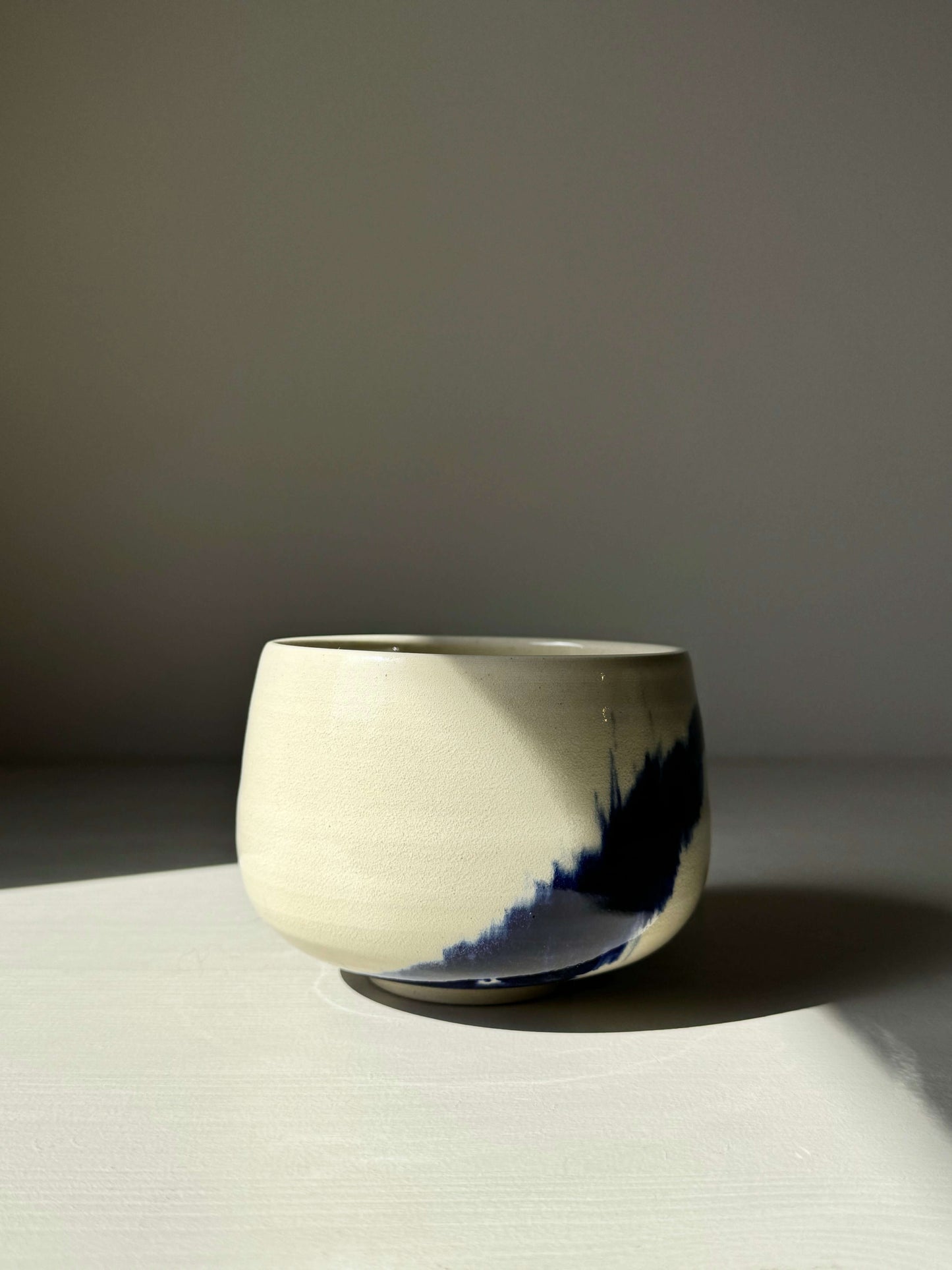 Rounded Matcha Bowl from Gosu Series with cobalt glaze band, reflecting nature-inspired design and rounded shape.