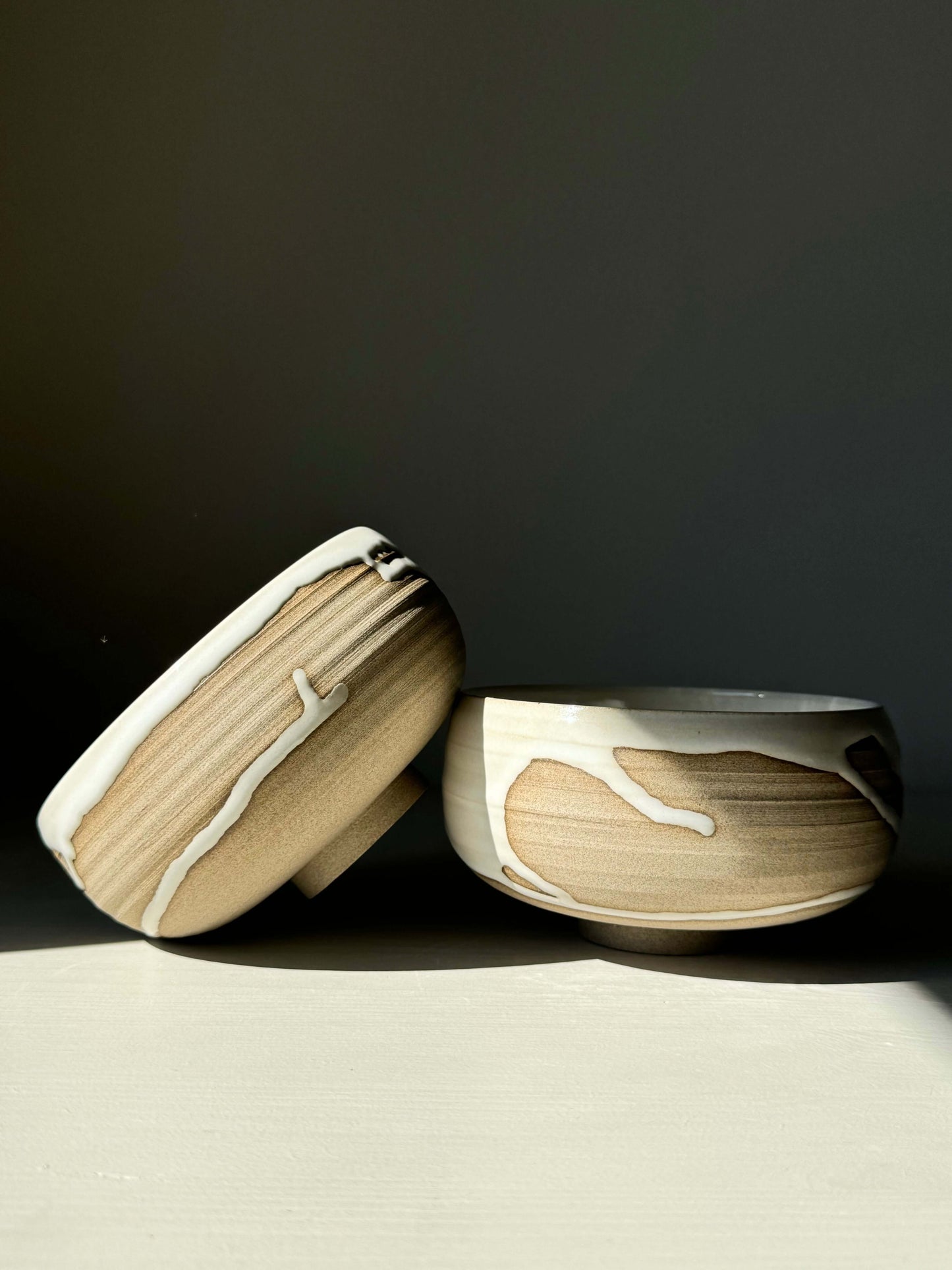 Rounded breakfast bowls from the Yuki Series, handcrafted with toffee clay and white glaze, perfect for granola or soup.