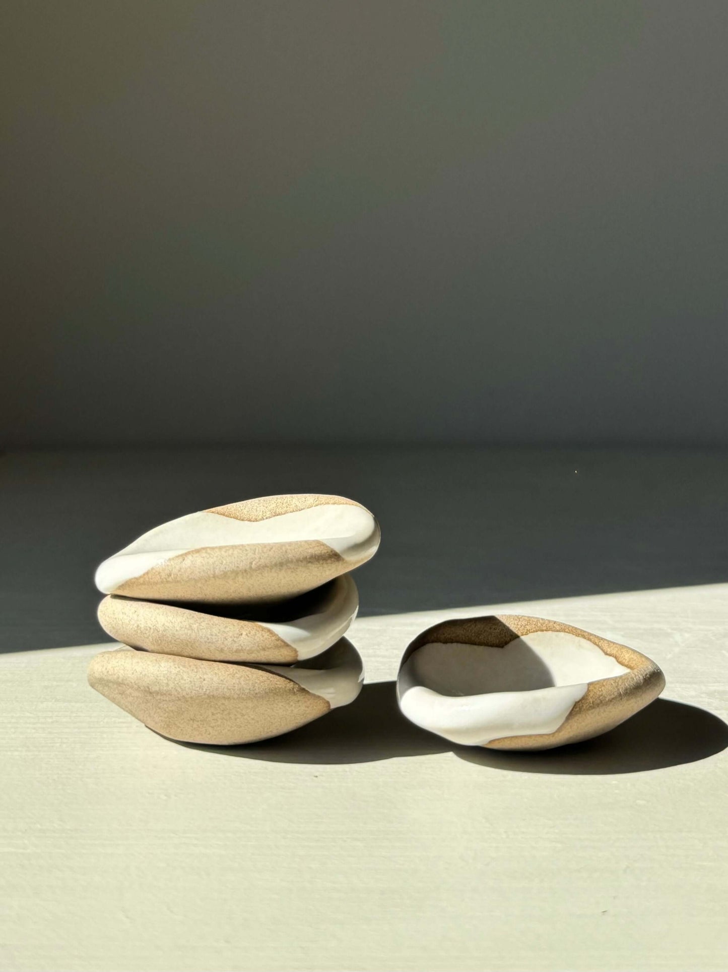 Rounded Chopstick & Matcha Spoon Rests from Yuki Series with white glaze and raw clay, handmade with organic curves for serene dining.