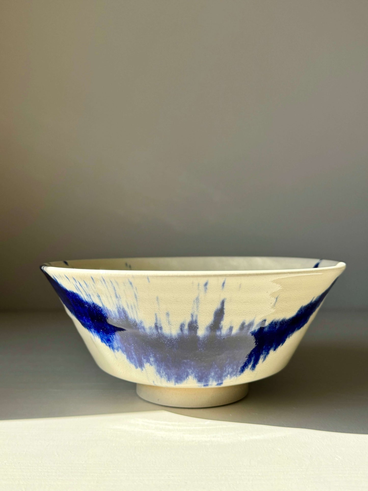 Gosu Series #03 serving bowl with blue pattern and elevated foot, inspired by Japanese style; ideal for functional and decorative use.