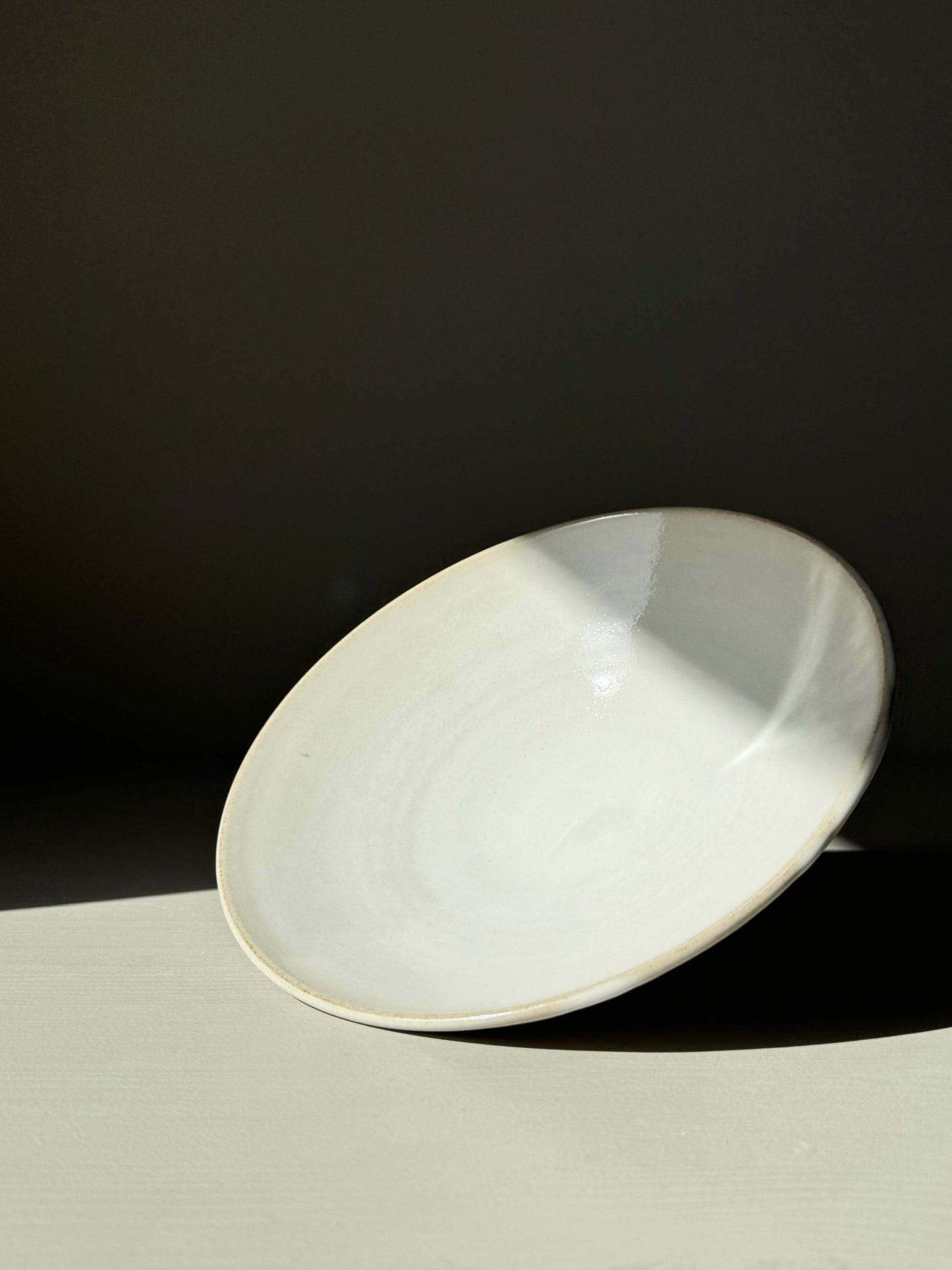 Shallow Bowl from Yuki Series with glossy white glaze, ideal for fruit or decor. Warm toffee-toned stoneware, 19cm diameter.