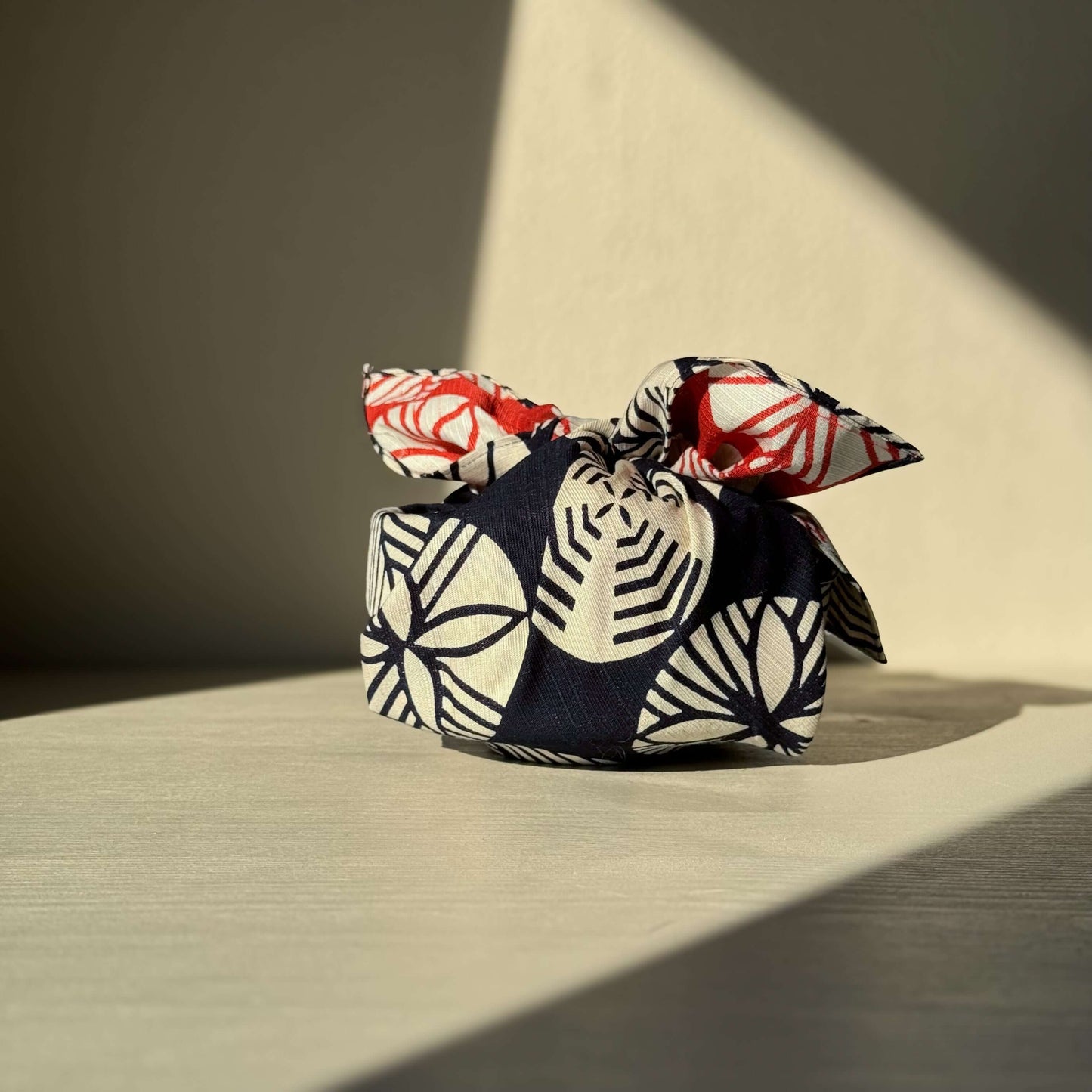 Small Furoshiki - Navy Blue & Red cloth wrap on bright surface, inspired by Japanese pine tree, handmade ceramic wrapping.