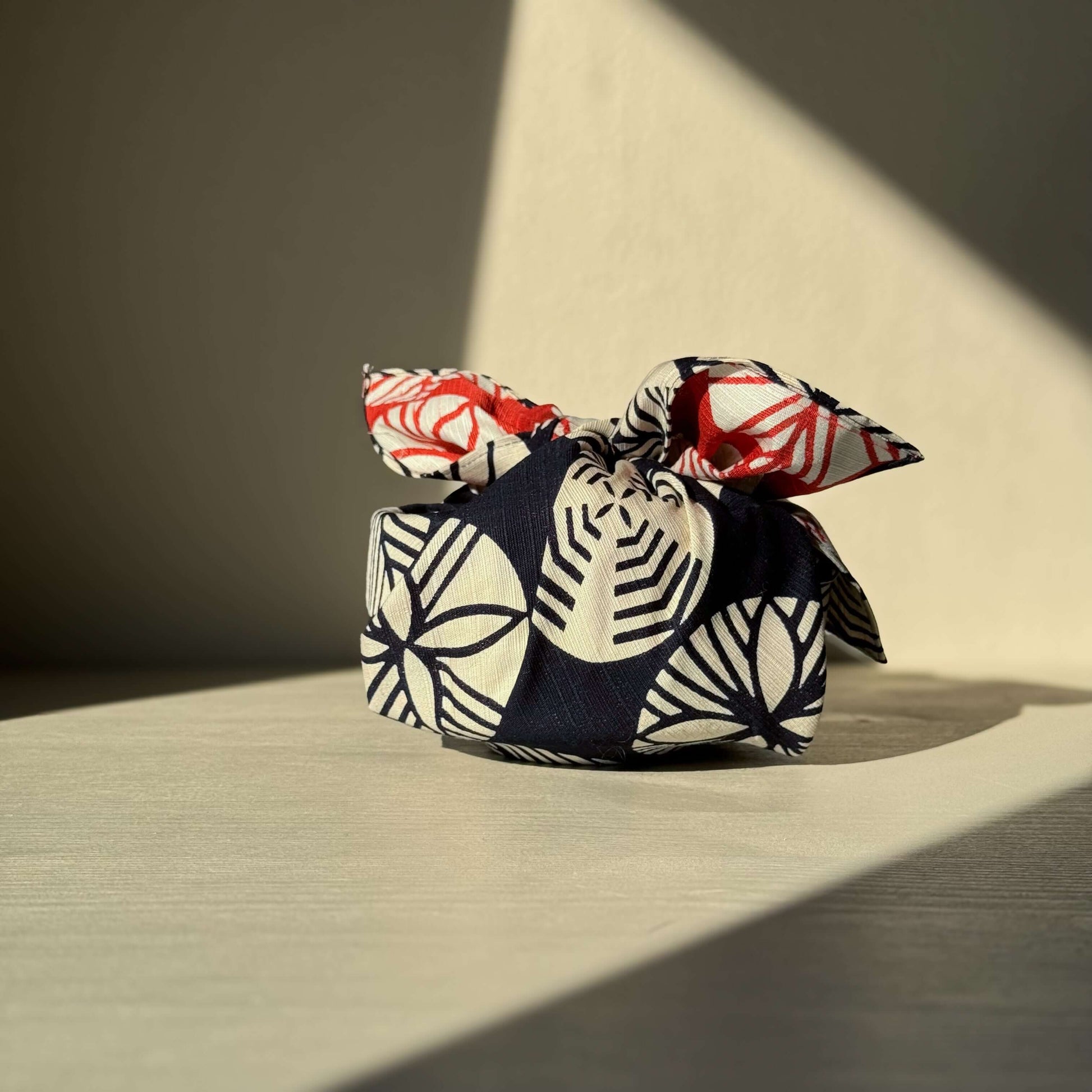 Small Furoshiki - Navy Blue & Red cloth wrap on bright surface, inspired by Japanese pine tree, handmade ceramic wrapping.