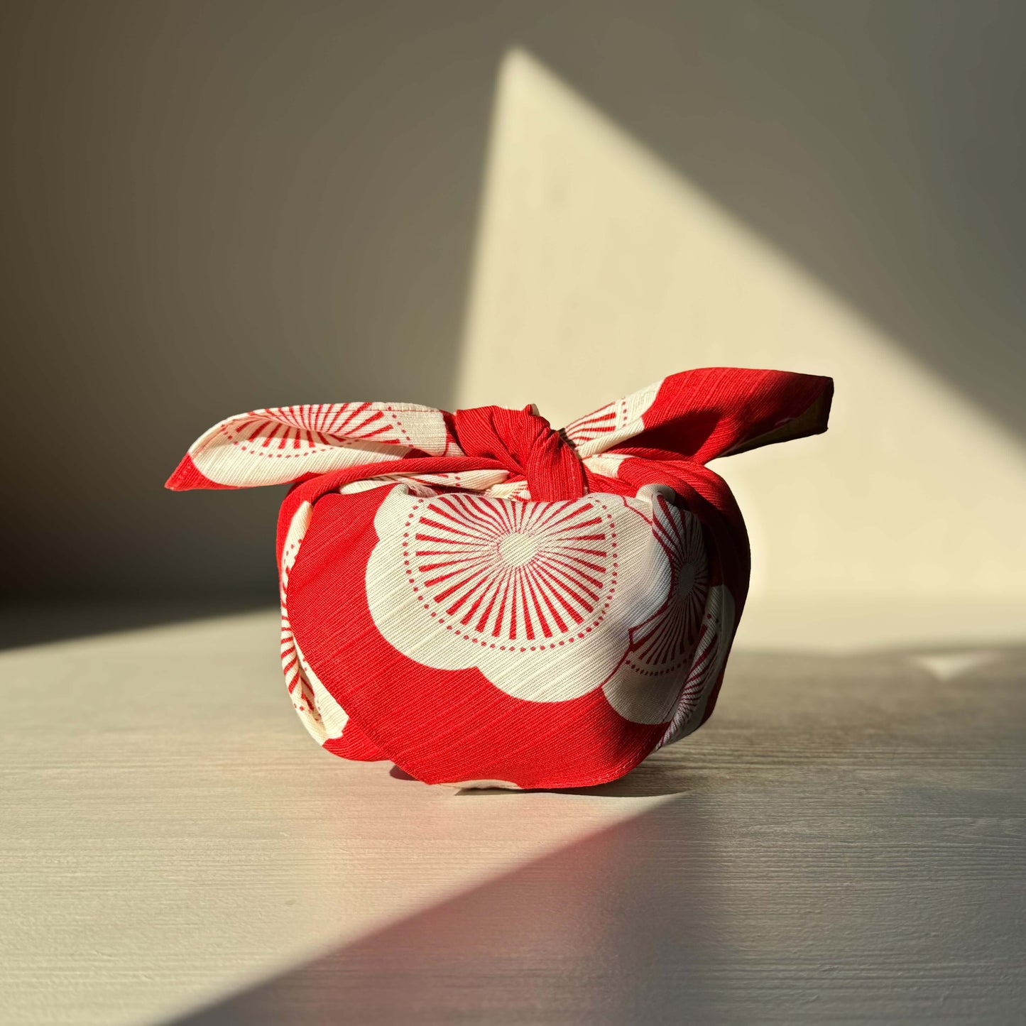 Red and green small Furoshiki with plum blossom design, symbolizing happiness. Eco-friendly gift wrap option.