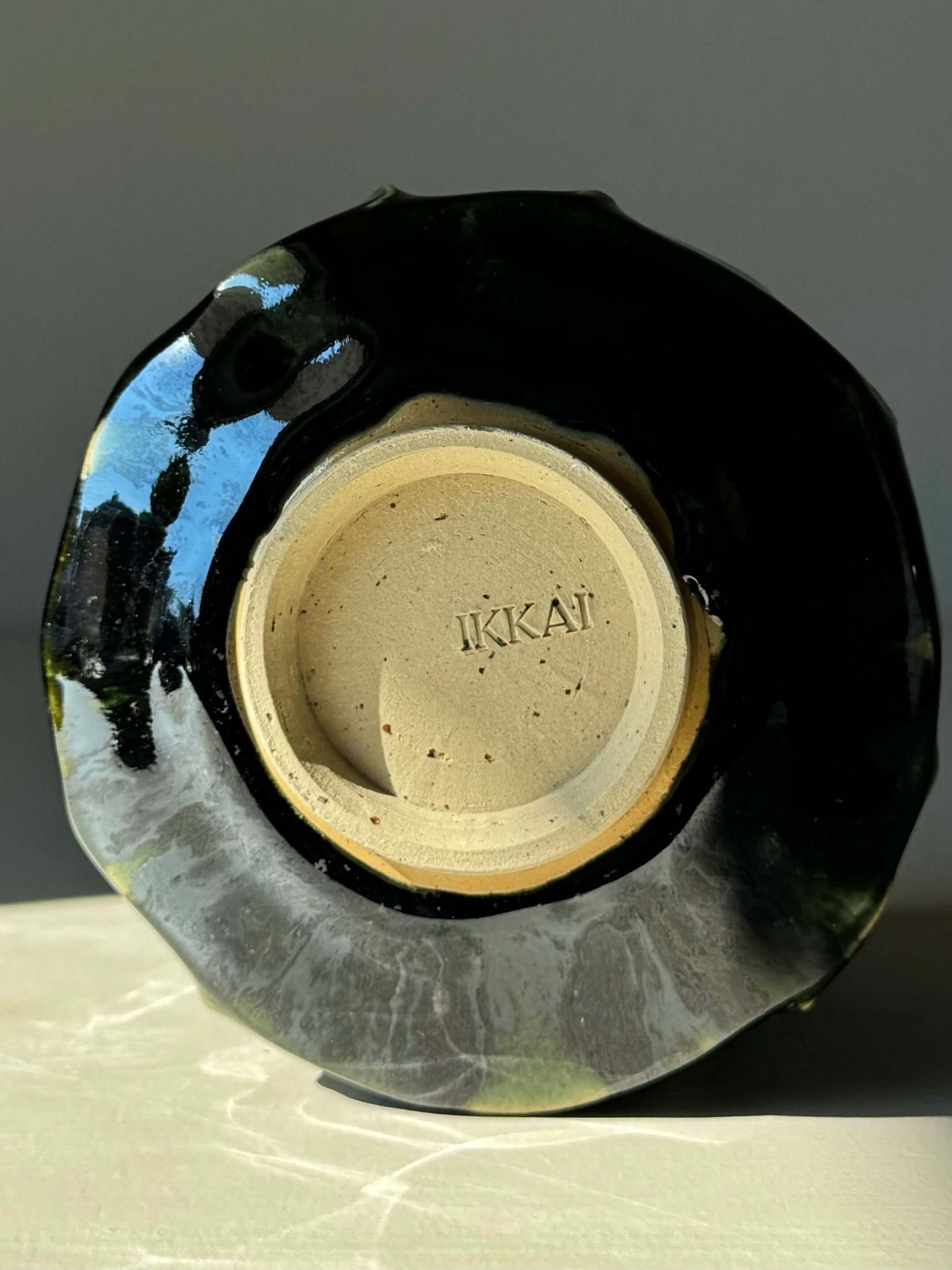 Underside view of the Textured Matcha Bowl from the Hinoki Series #01 with unique green glaze and handcrafted inscription.