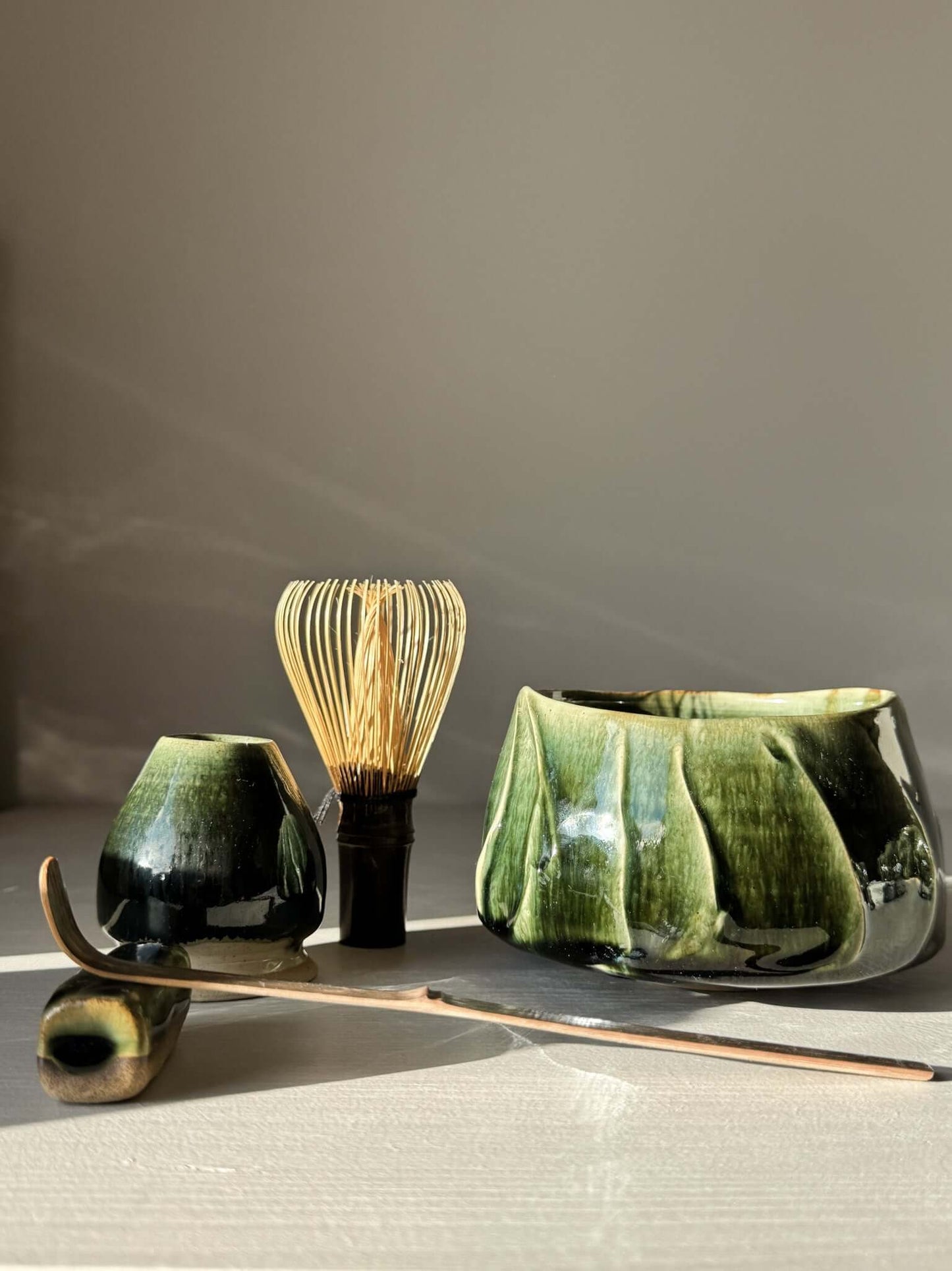 Textured Matcha Bowl - Hinoki #05 with green glaze, part of Hinoki Series, alongside matcha whisk and accessories.
