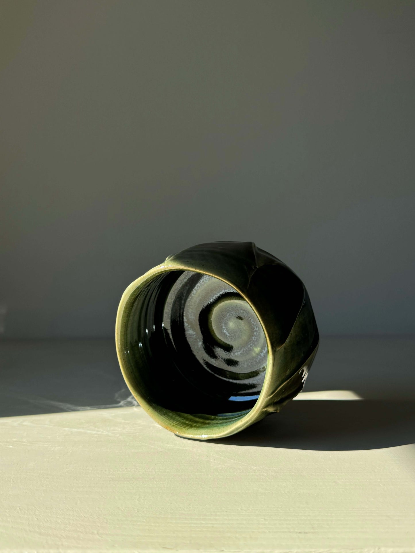 Textured Matcha Bowl from Hinoki Series #11 with green glaze, showcasing unique craftsmanship and natural beauty in sunlight.