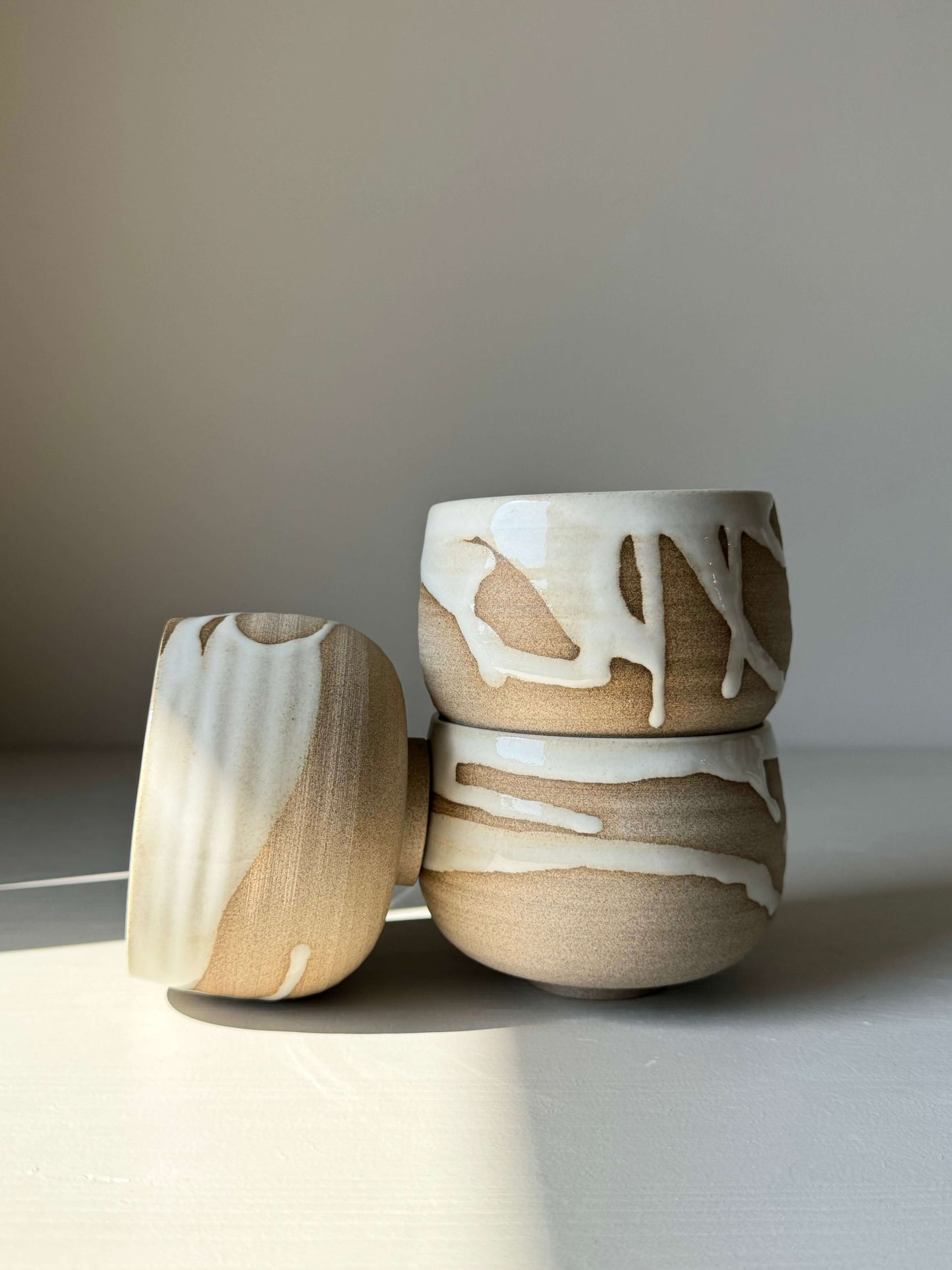 Yuki Series coffee cups with unique white glaze on warm clay, showcasing quiet beauty and individual personality.