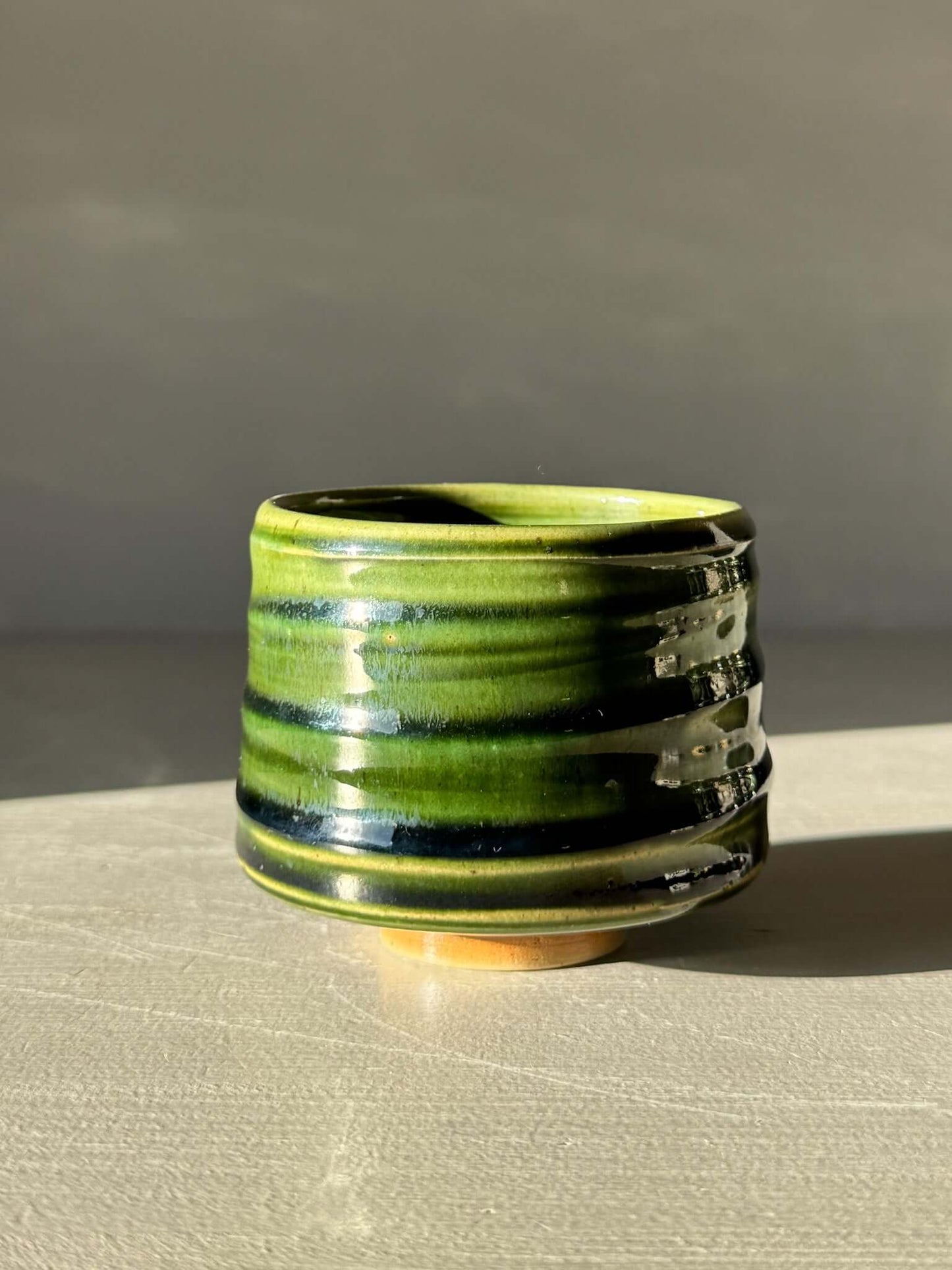 Yunomi Cup - Hinoki #10 with hand-decorated slip and deep green glaze, showcasing unique texture and artisanal craftsmanship