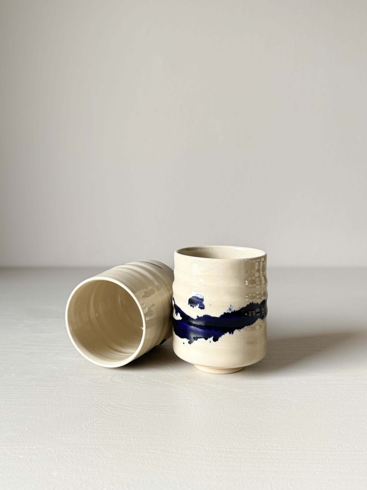 Handmade ceramic Yunomi Cups - Gosu Series with cobalt blue splashes, crafted on wheel, finished with clear glaze, compact design