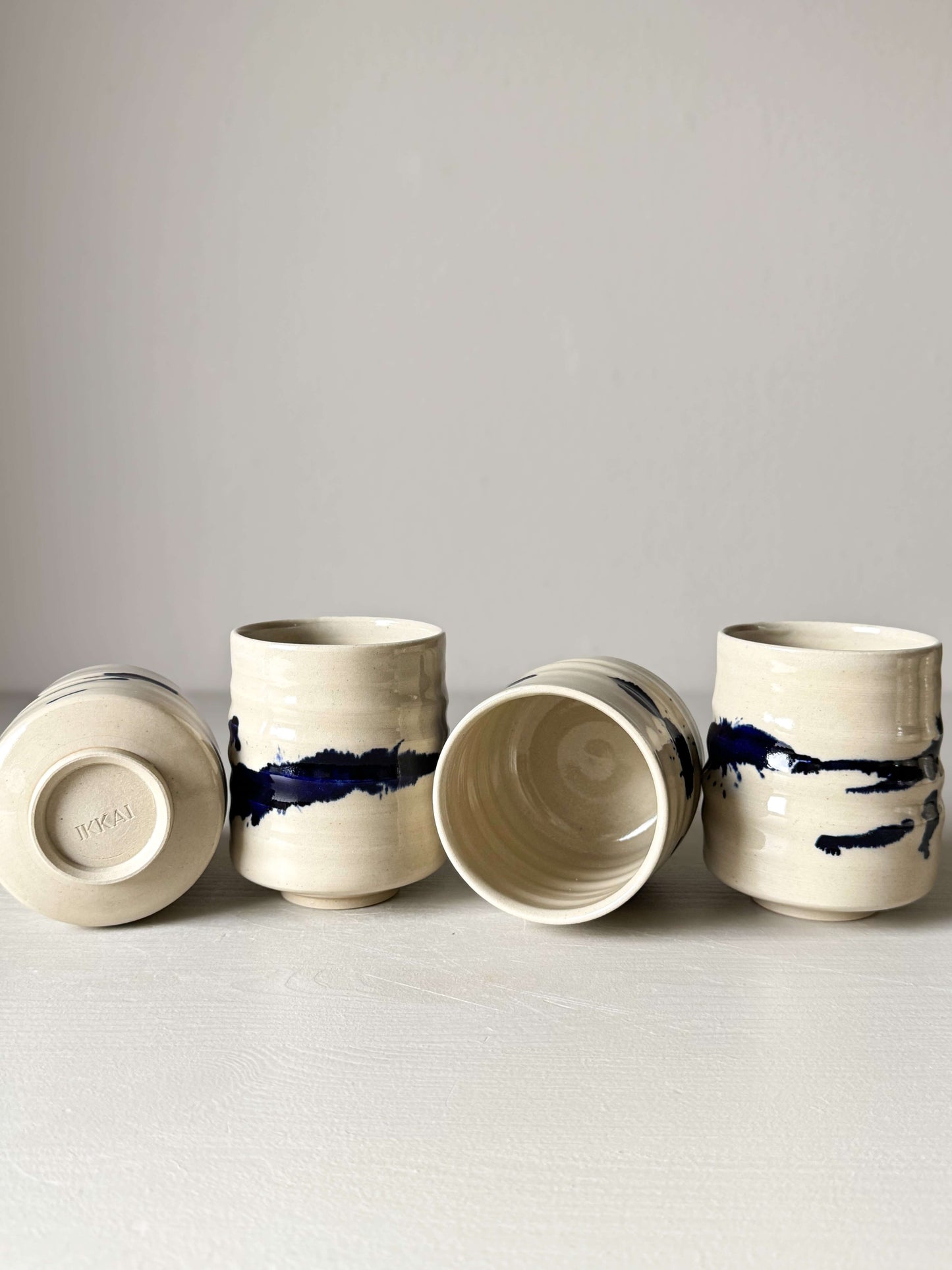 Yunomi Cups - Gosu Series handmade ceramic cups with cobalt blue splashes, displaying artistic spontaneity and traditional craftsmanship.