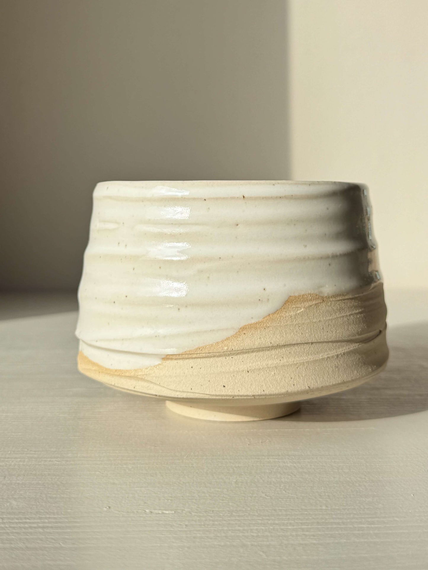 Handmade Matcha Bowl – Half Glossy White Glaze #01 with speckled stoneware clay and textured surface, ideal for tea preparation.