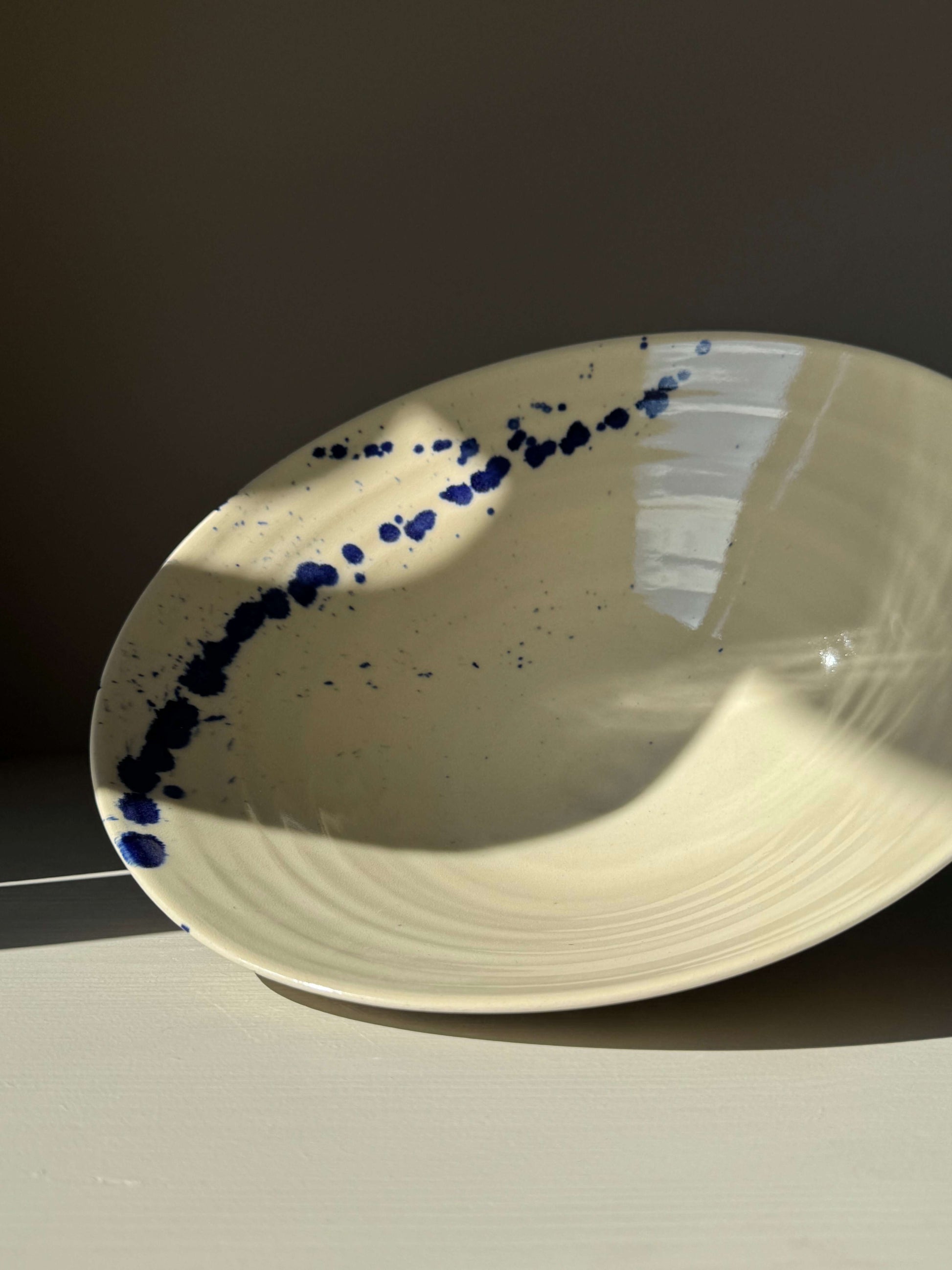 Handmade ceramic Medium Bowl - Gosu Series #01 with cobalt splashes and natural form, transparent glaze creating a dynamic look.