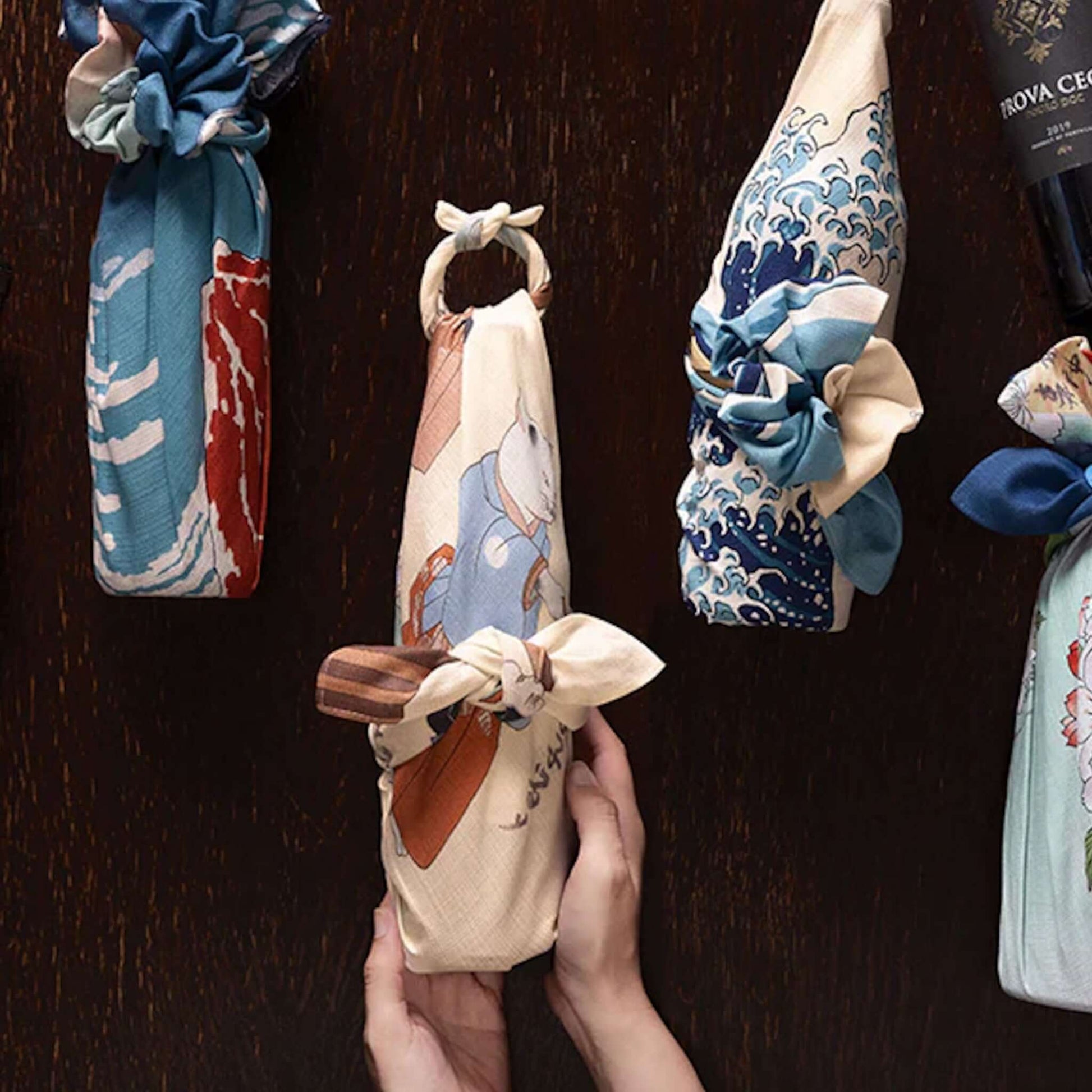 Medium Furoshiki Cats Juggling Balls Pattern wrapped in beautiful fabric designs, showcasing traditional gift-wrapping styles.