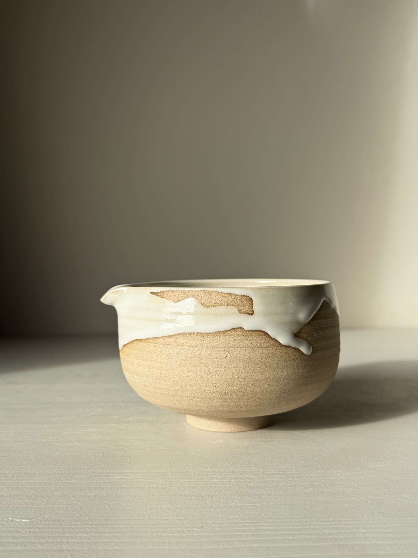 Handmade ceramic Matcha Bowl with Spout – Yuki #01, featuring toffee clay and a glossy white glaze in a unique design.