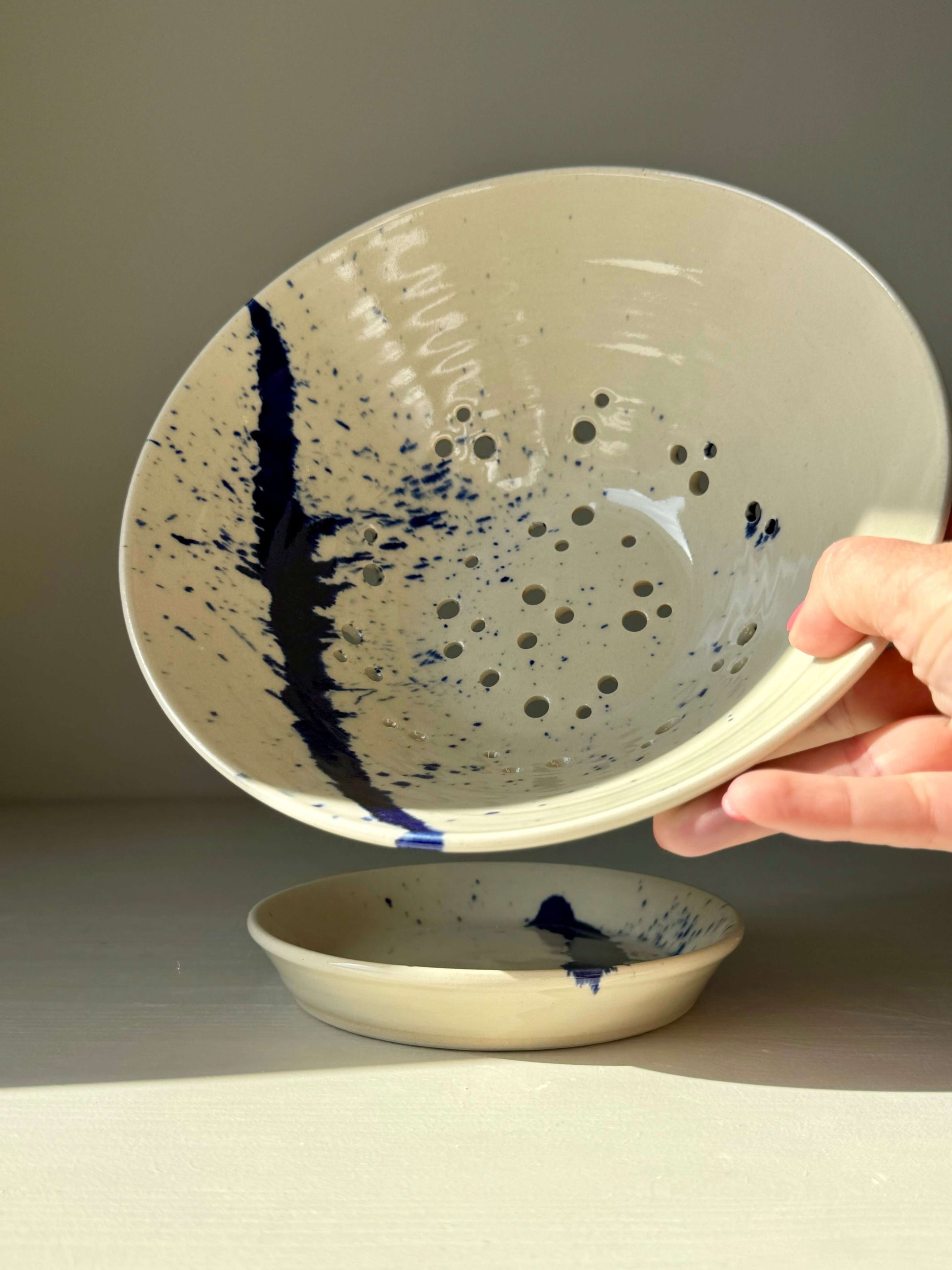 Sculptural berry bowl from Gosu Series with cobalt splashes, perfect for rinsing strawberries, cherries, blueberries, with matching drip plate.