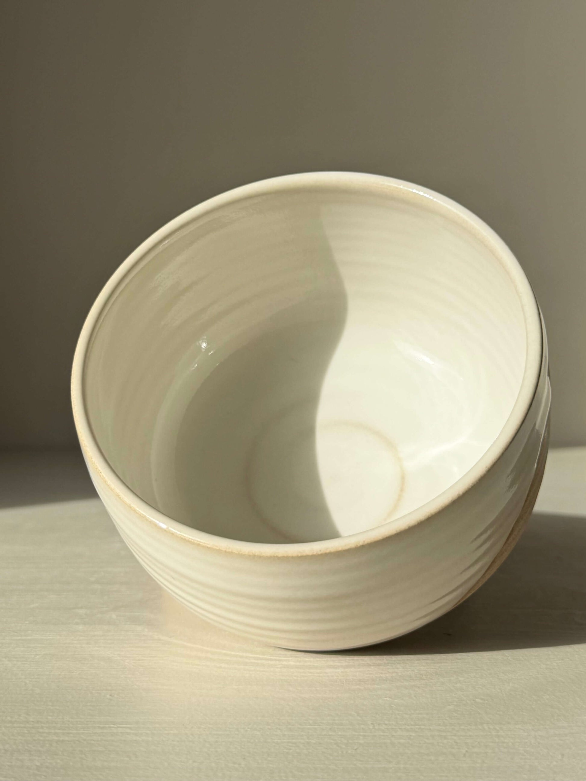 Matcha Bowl – Yuki #01 featuring handmade ceramic design with glossy white glaze and toffee clay, showcasing unique wheel-thrown craftsmanship.