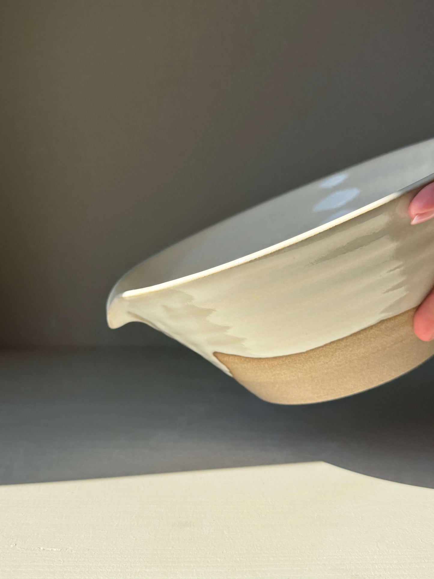 Handmade ceramic Pouring Bowl – Yuki Series with creamy white glaze and carved spout.