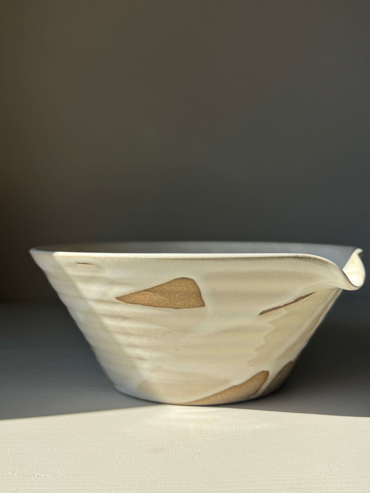 Pouring Bowl – Yuki Series, handmade ceramic with creamy glaze, showcasing a sculptural design and functional spout.