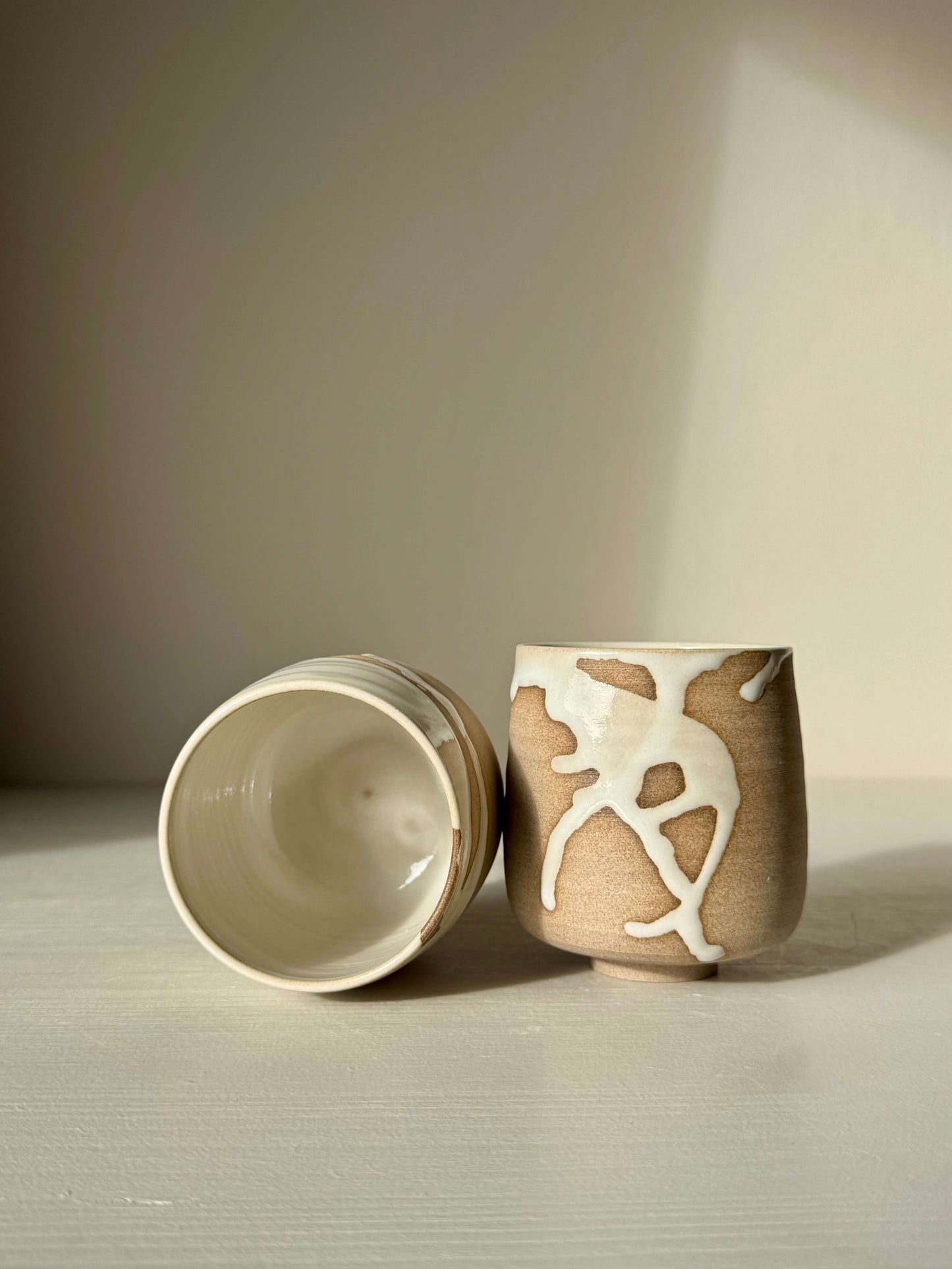 Handmade ceramic Yunomi Cups - Yuki with white glaze and toffee clay showing unique drip patterns and glossy finish.