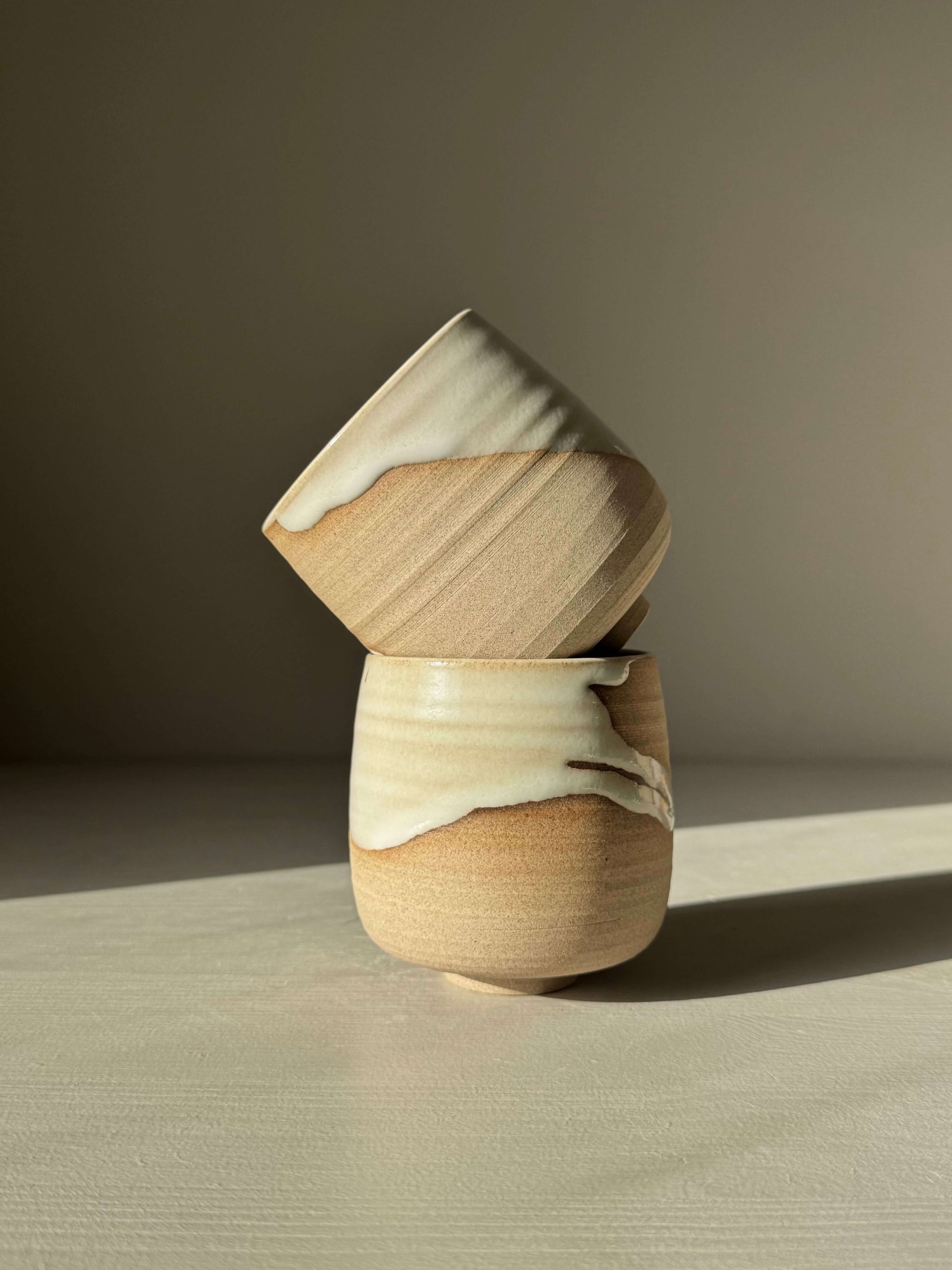 Handmade ceramic Yunomi Cups - Yuki with white glaze over toffee clay, showcasing unique drips and texture contrast.