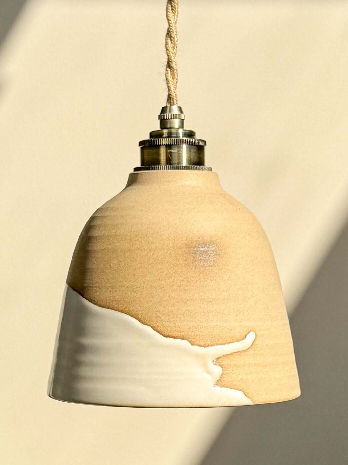 Ceramic Lamp Shade – Yuki #04 with raw clay and glossy white glaze contrasts, featuring a tall design concealing the light bulb.