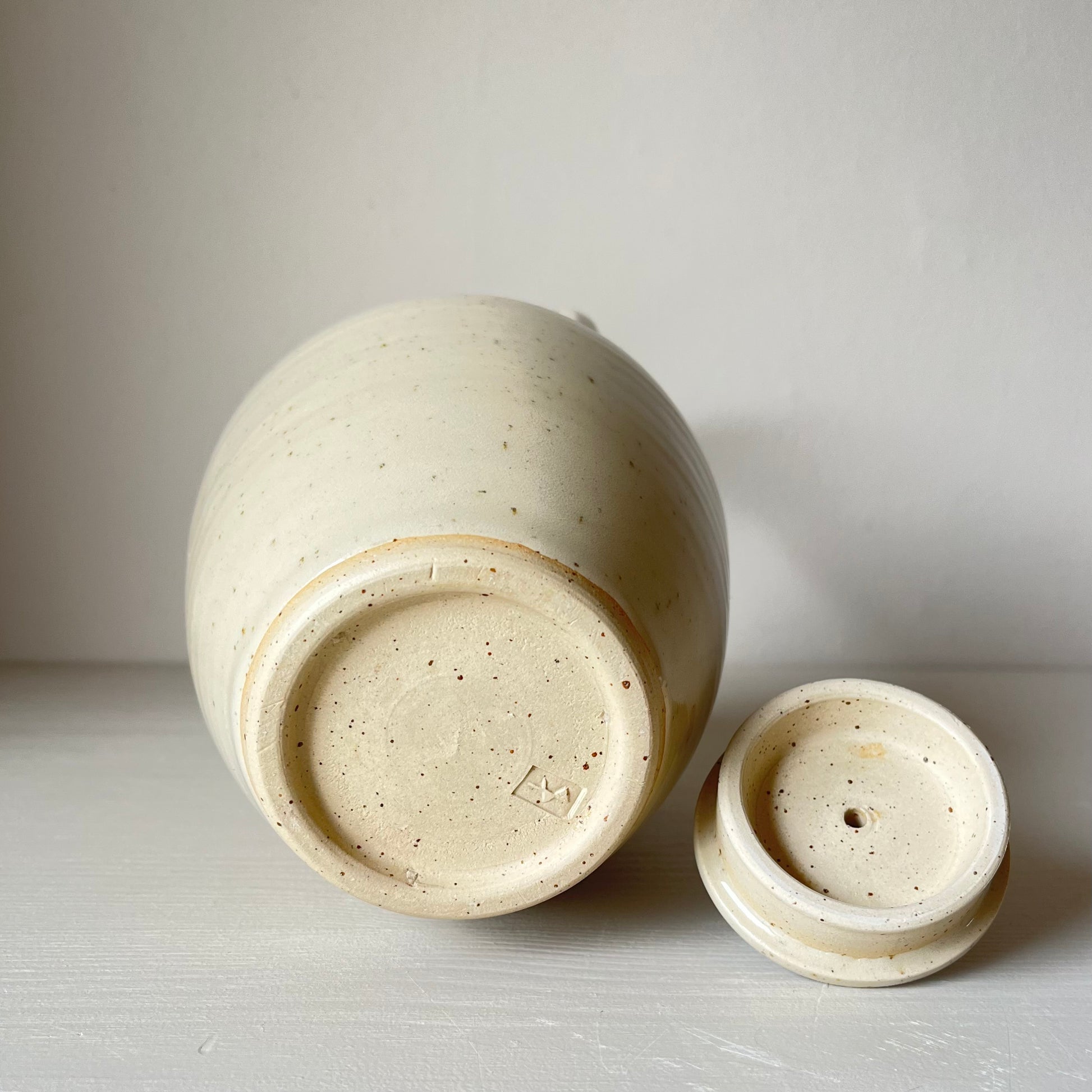 bottom view of a large cream handmade ceramic teapot