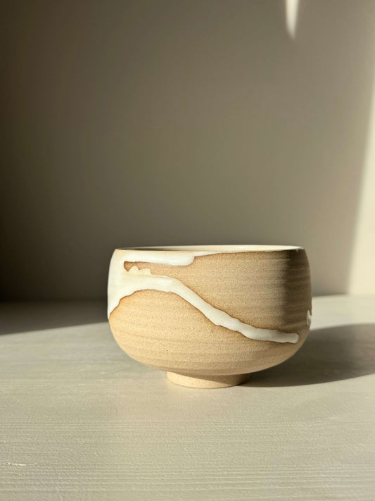 Handmade ceramic Matcha Bowl – Yuki #02 with toffee clay and white glaze, showcasing unique design and craftsmanship.