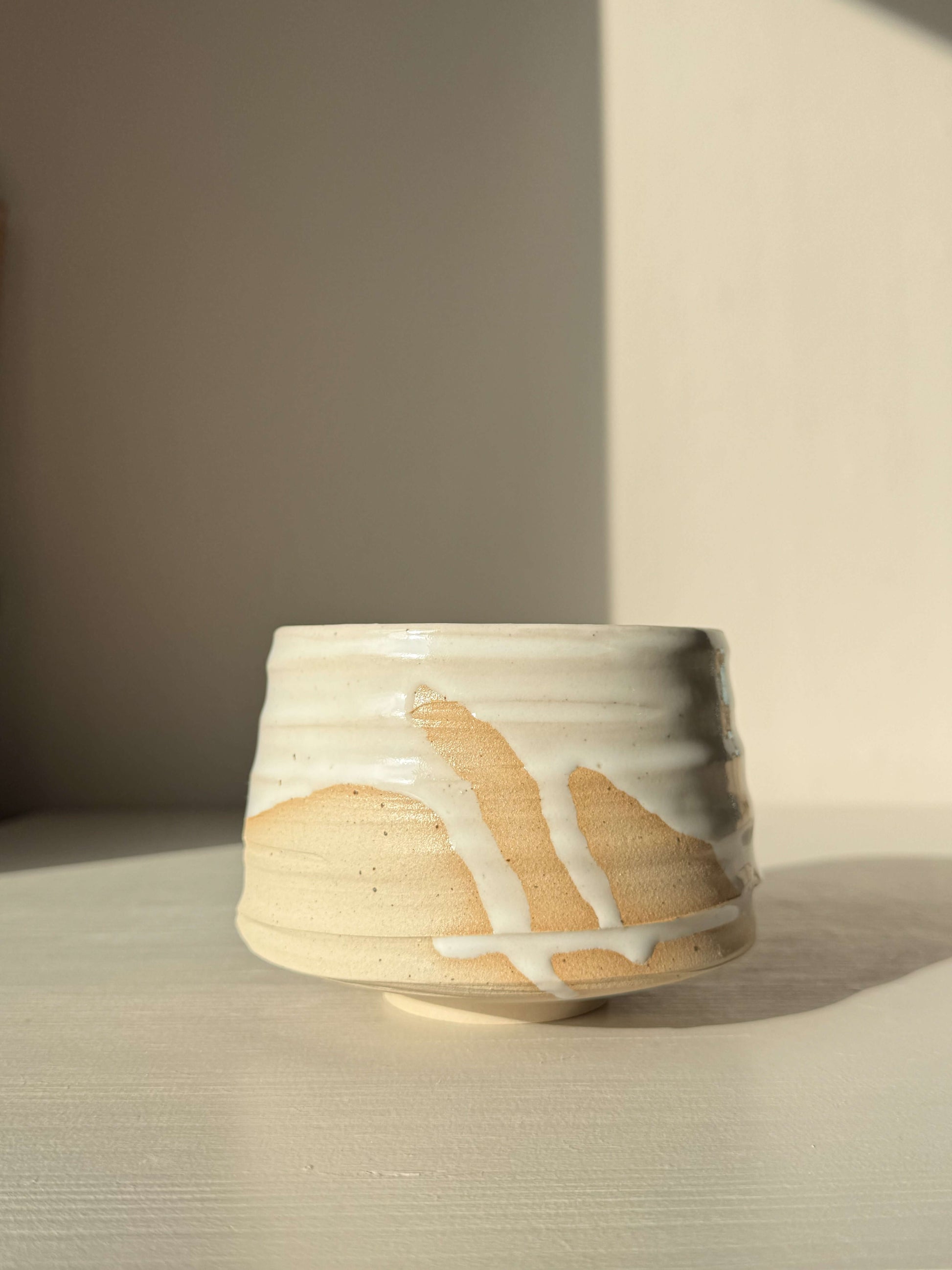 Matcha Bowl – Half Glossy White Glaze #01 handmade ceramic with speckled stoneware clay and tactile surface showing glaze drips.