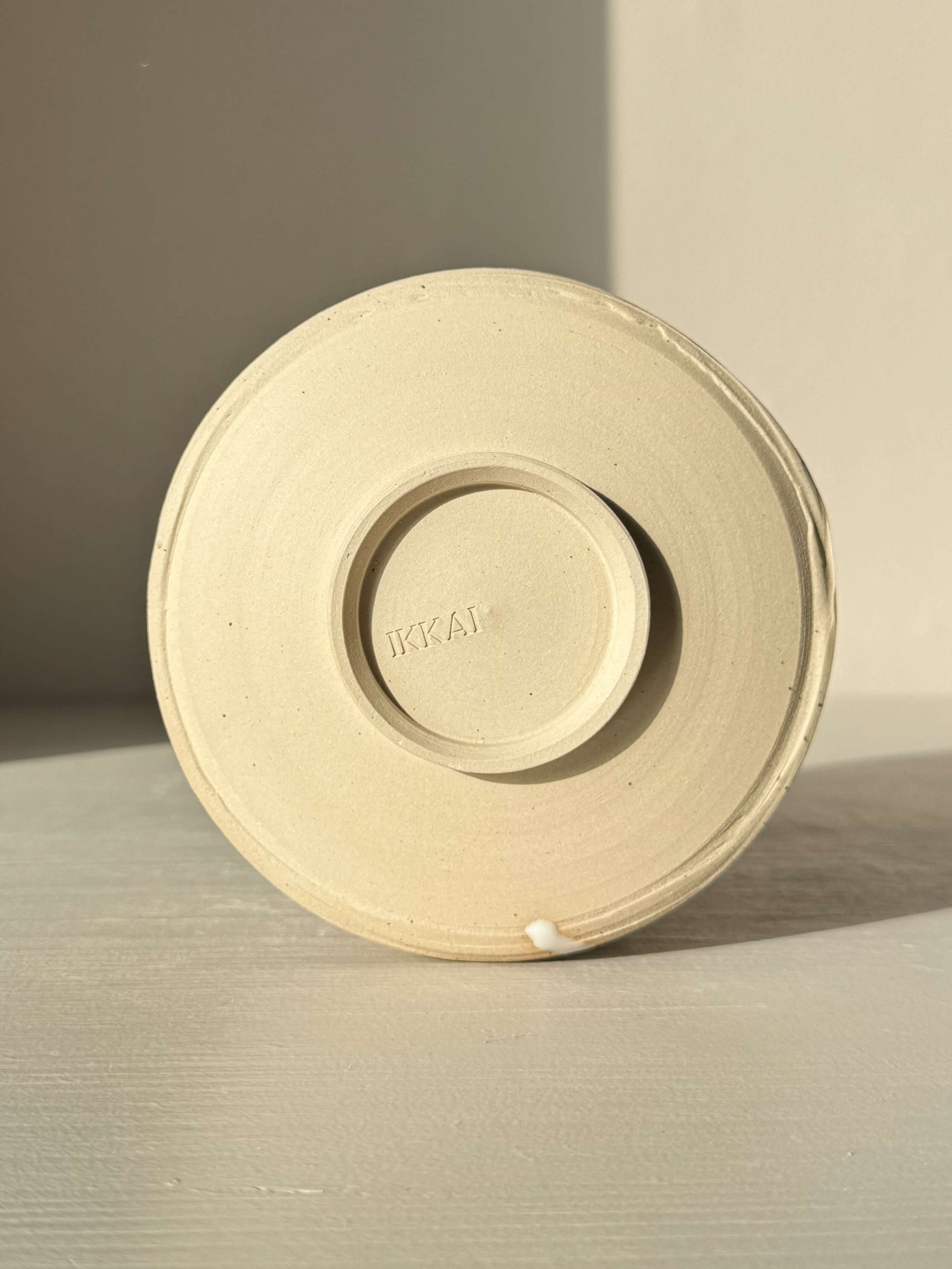 Base of Matcha Bowl – Half Glossy White Glaze #01 made from speckled stoneware clay, showing unique handmade ceramic texture.