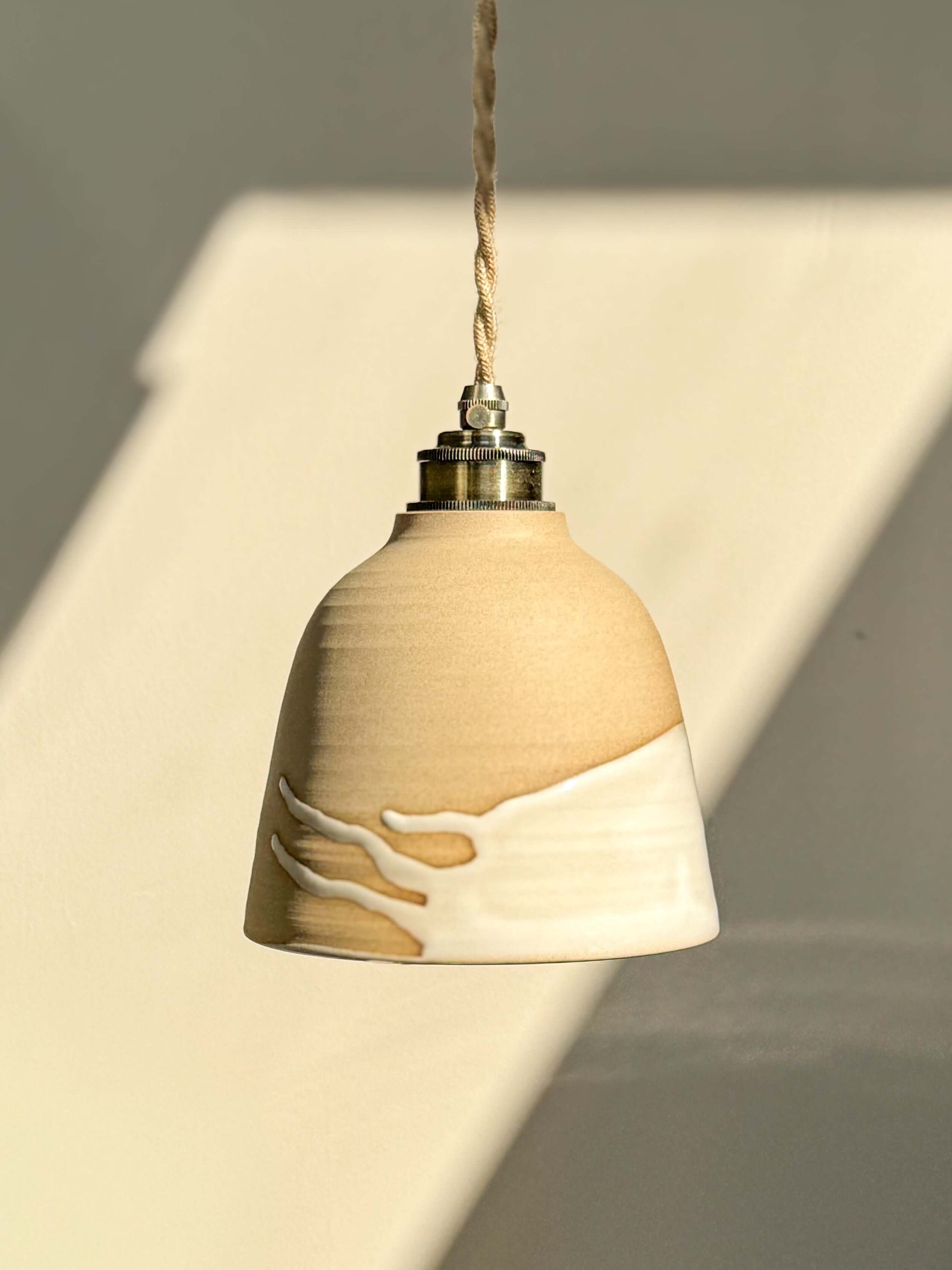 Ceramic Lamp Shade – Yuki #04 with raw clay finish and white glaze accent, designed to conceal the bulb entirely inside.
