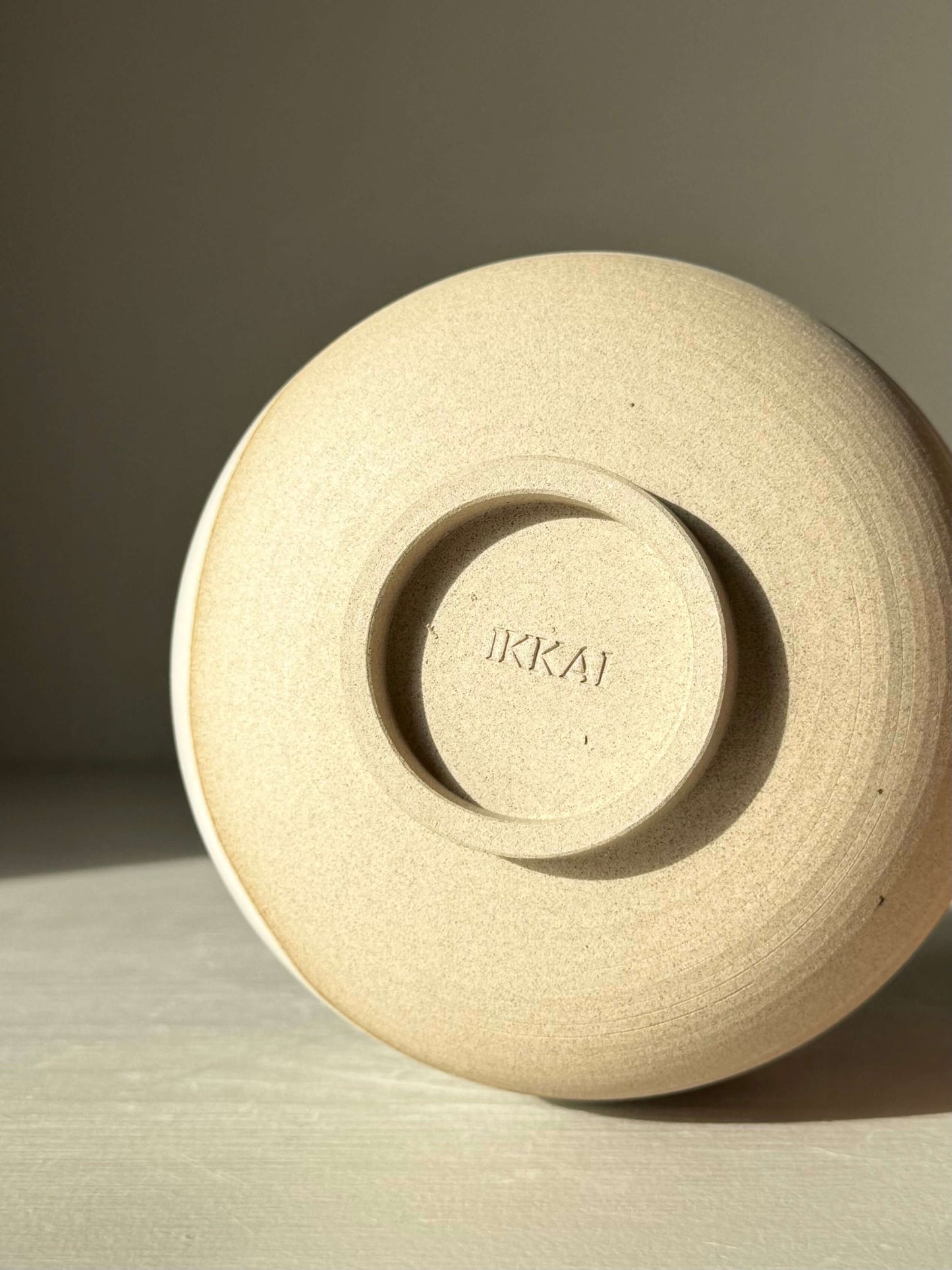 Matcha Bowl – Yuki #01 handmade ceramic base with artist's signature, showcasing raw toffee clay texture.