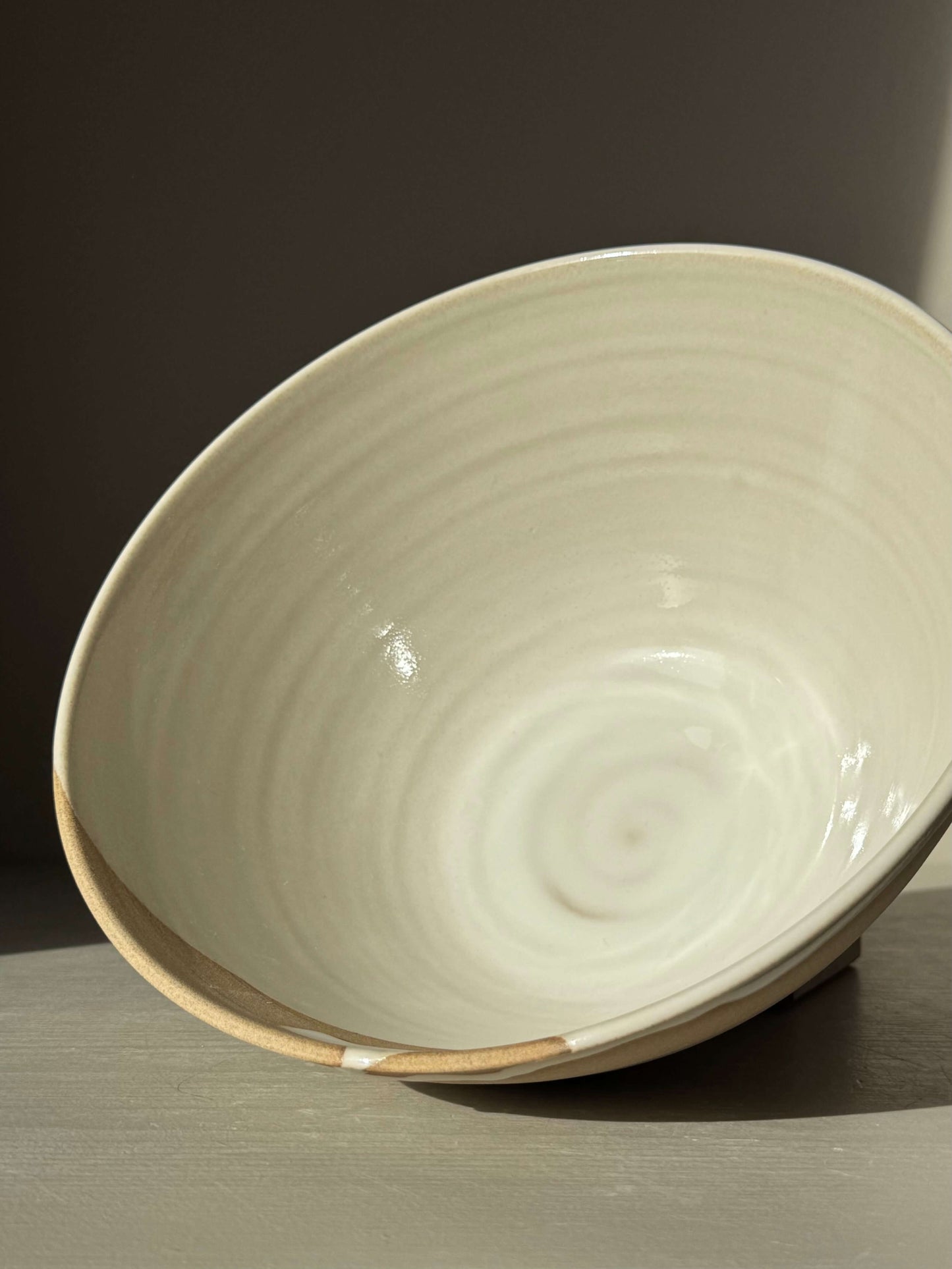 Handmade ceramic Medium Bowl - Yuki #02 with glossy white glaze and raw clay exterior, perfect for center table use.