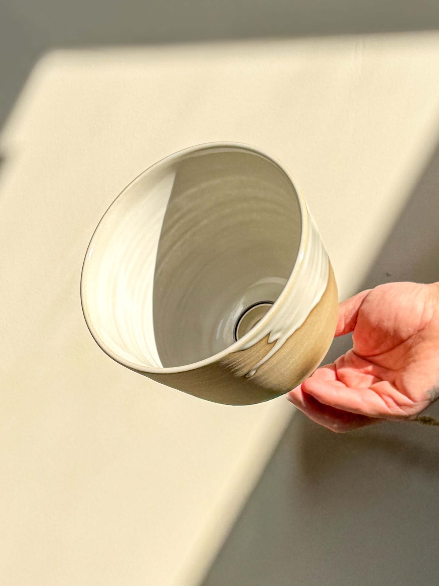 Ceramic Lamp Shade – Yuki #04 with glossy white glaze inside and warm raw clay exterior held in hand