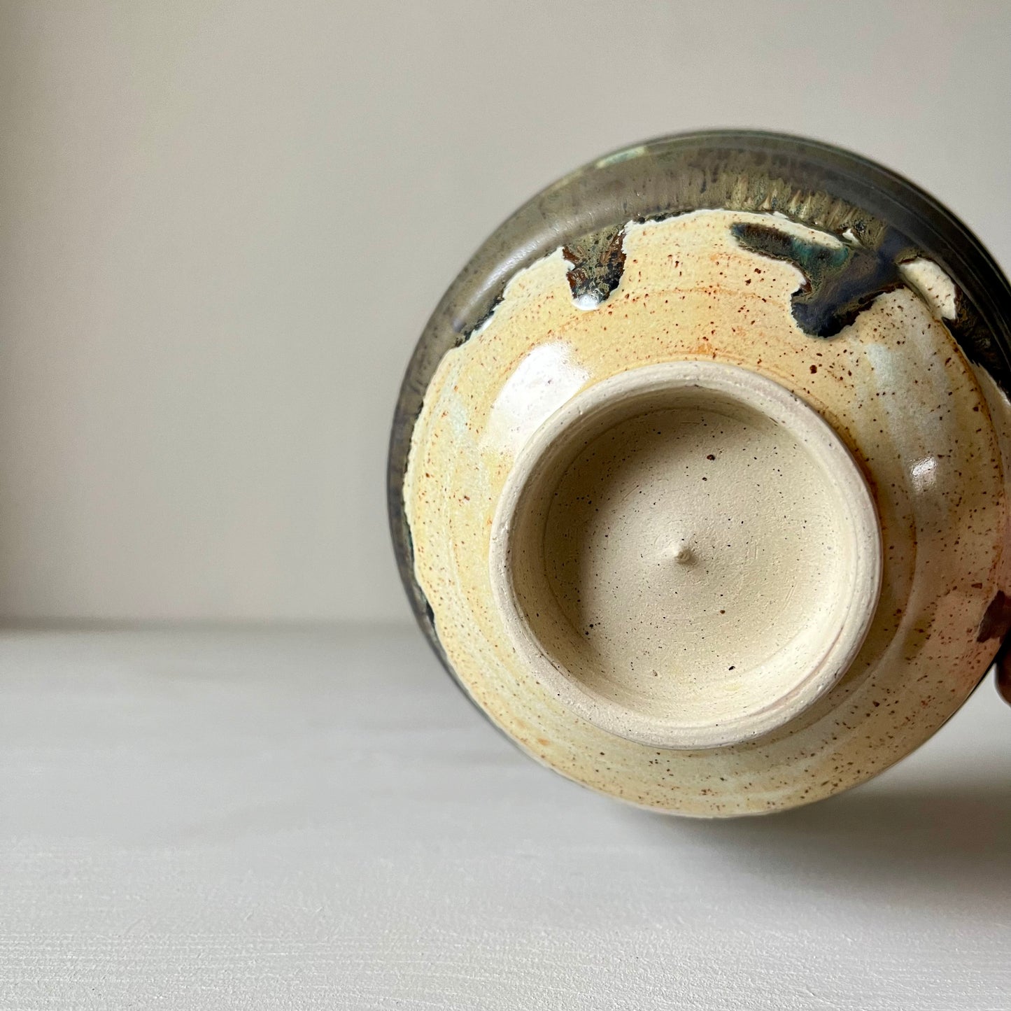 A view of the bottom of a black ceramic matcha bowl