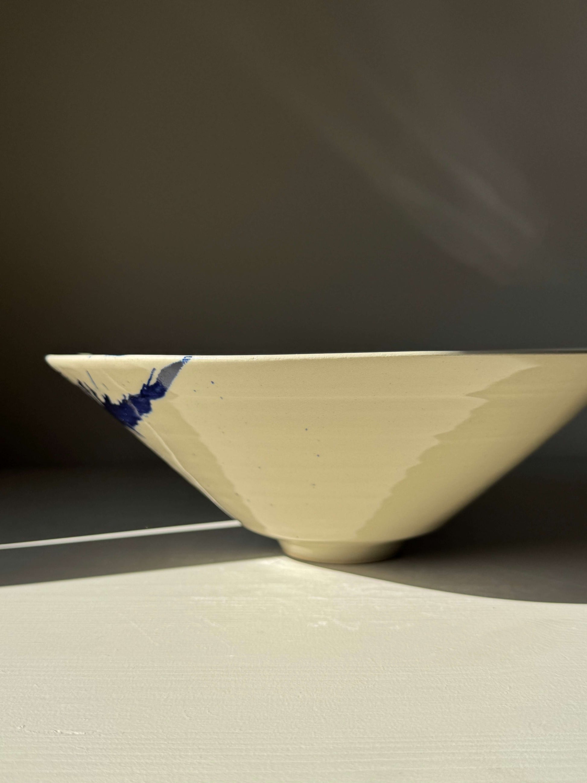 Medium Bowl - Gosu Series #01 handmade ceramic with cobalt splashes, natural form, and transparent glaze in side view.