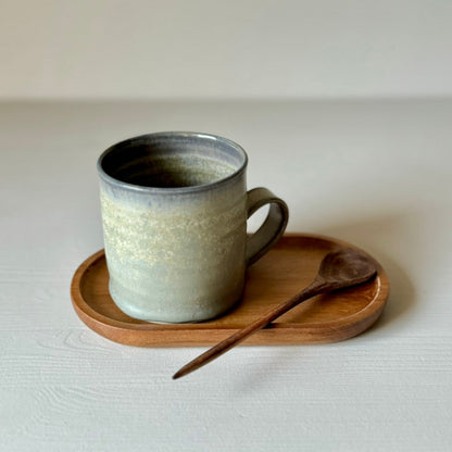 Blue handmade ceramic cup with wooden spoon