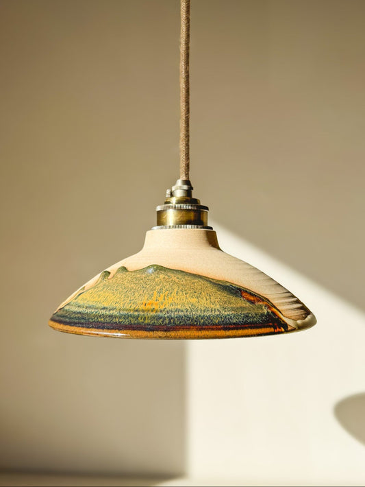 Handmade Inyo ceramic lampshade hanging against a warm beige background