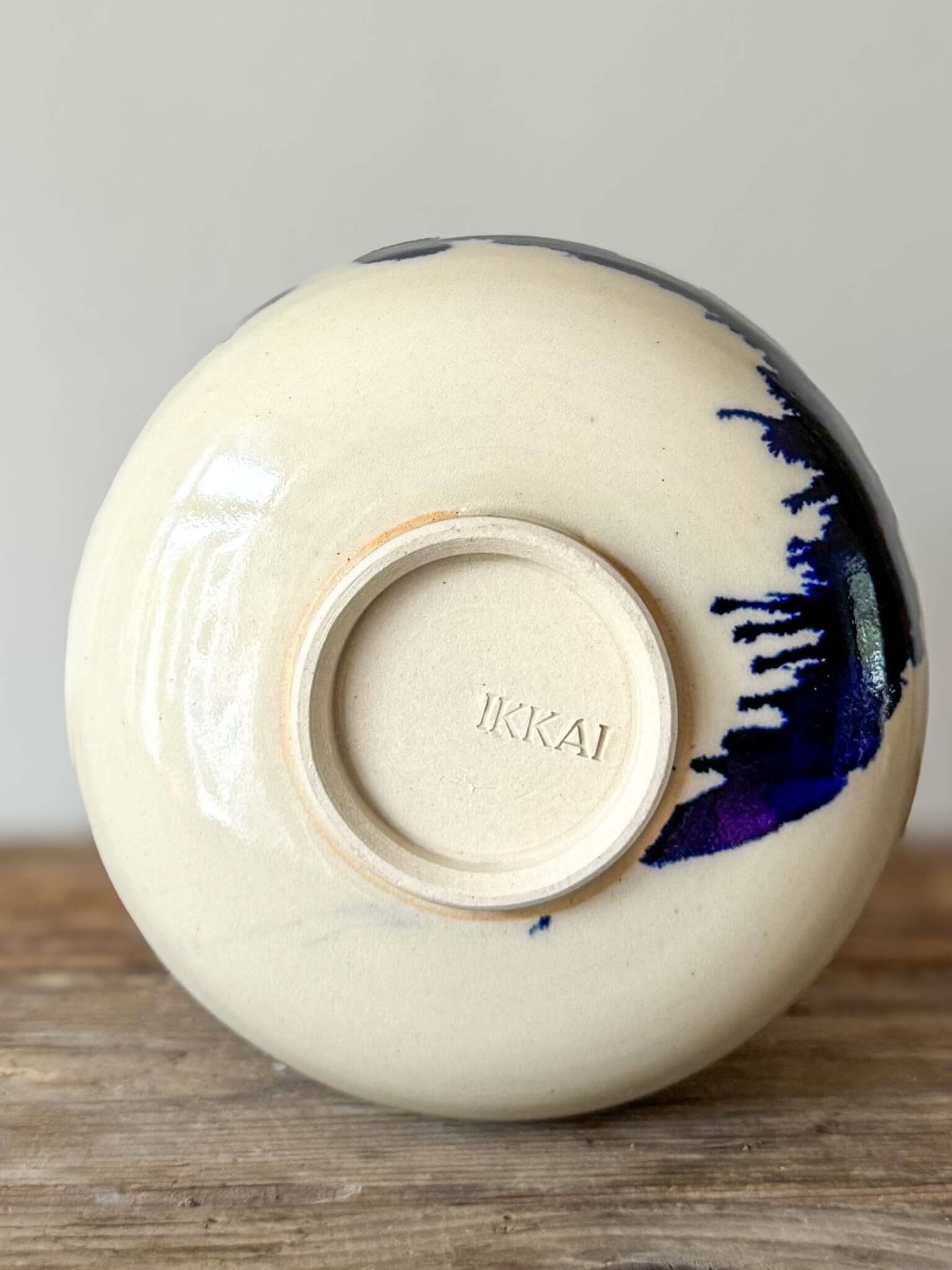 Bottom view of Katakuchi Matcha Bowl, Gosu Series, showing the cobalt blue glaze and spout on wood surface.