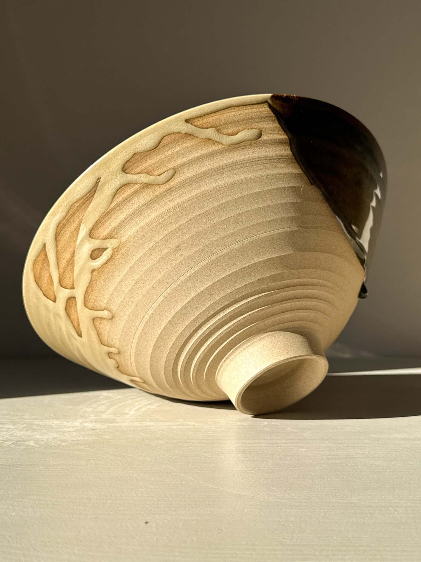Medium Bowl - Inyo #01 with a sculptural design and carved exterior, featuring golden tones and soft blue inside.
