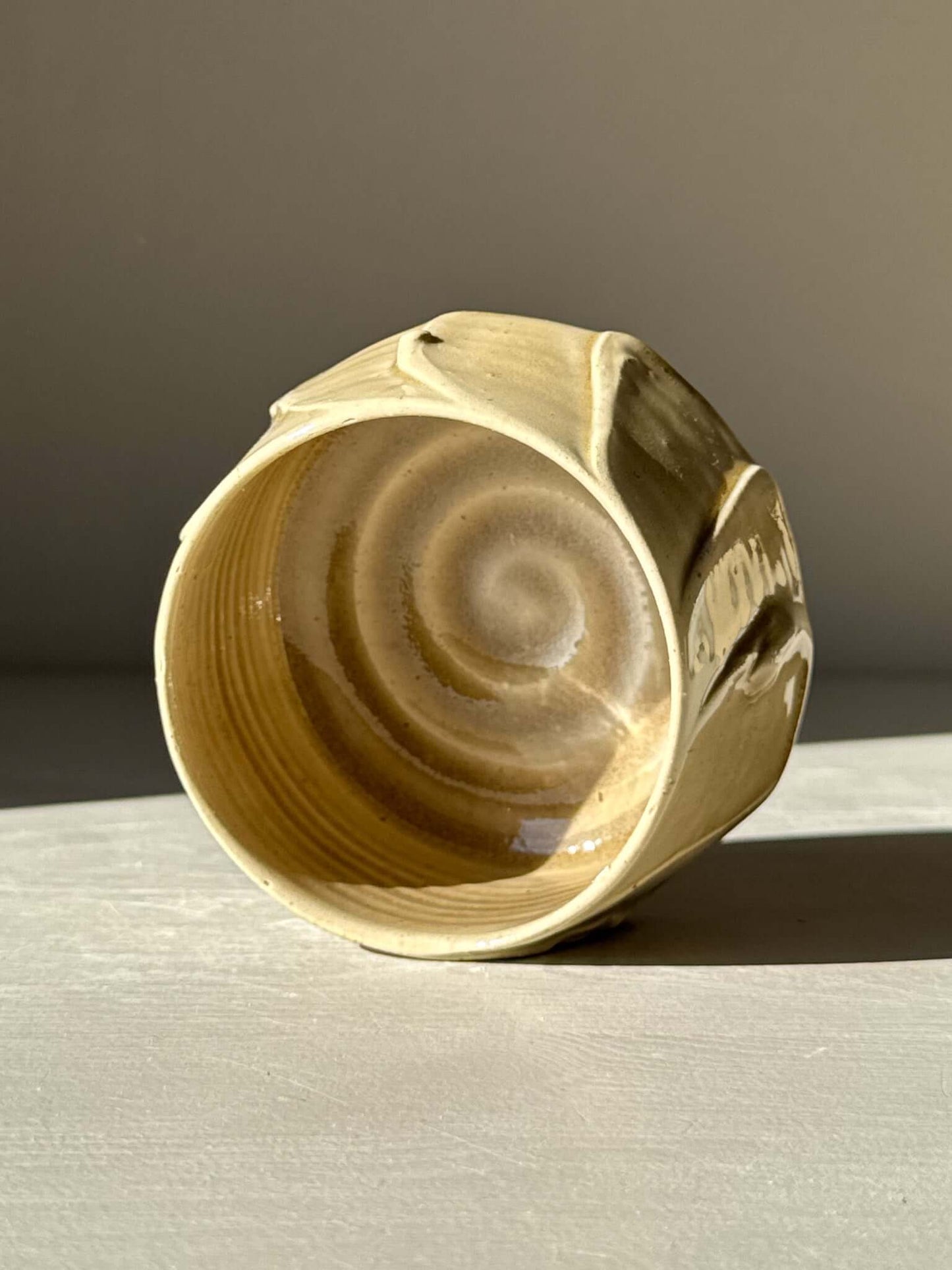 Yunomi Cup - Beige, a handmade ceramic cup with beige glaze, showcasing unique textures and natural swirl patterns from studio experimentation.