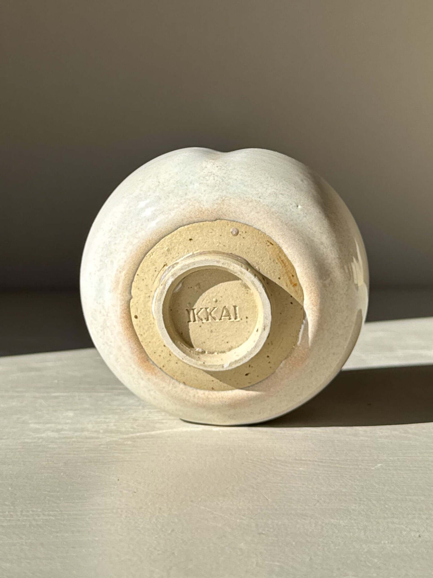 Base of Yunomi Cup - Pale Blue showcasing pale blue glaze and clay finish in sunlight.