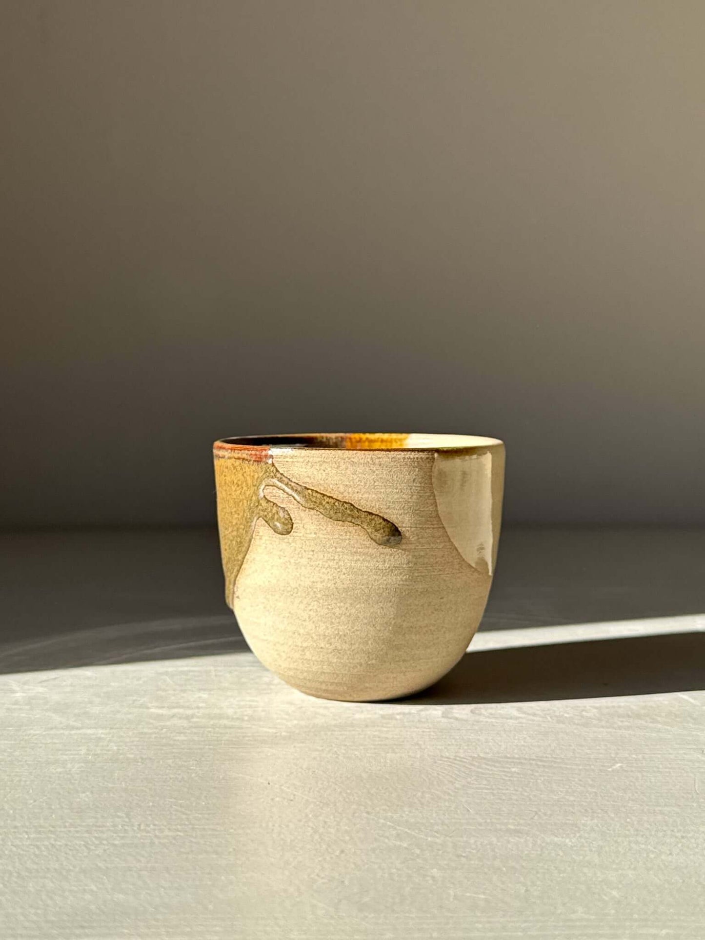 Espresso Cup - Inyo Series showcasing earthy tenmoku glaze and warm clay beneath.