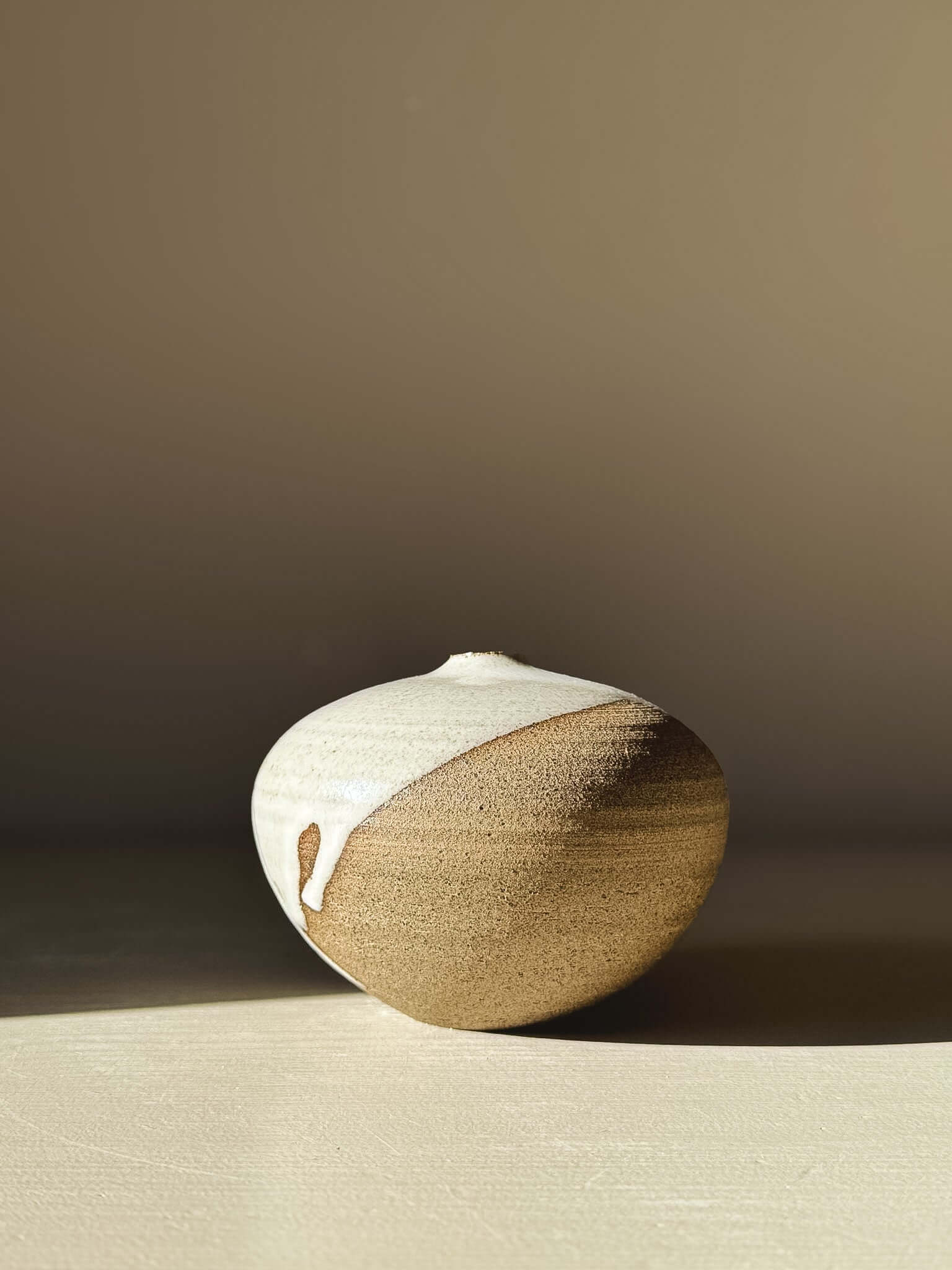 Sculptural Orb Vase – #08 with unique glaze patterns, showcasing a rounded form and calm presence.
