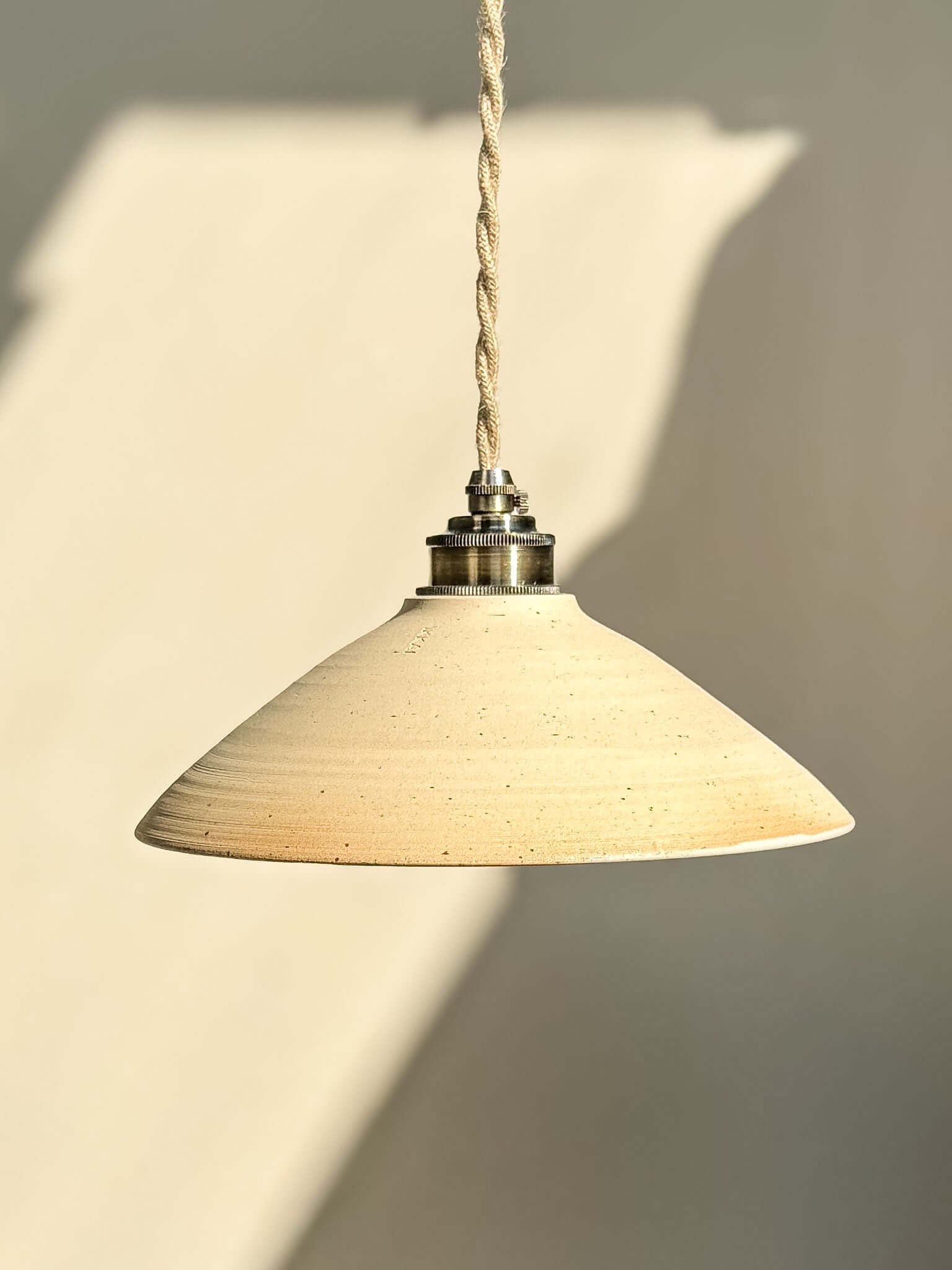 Ceramic Lamp Shade – Half Glossy White Glaze #02 with raw exterior and glossy interior, featuring a warm, radiant glow.