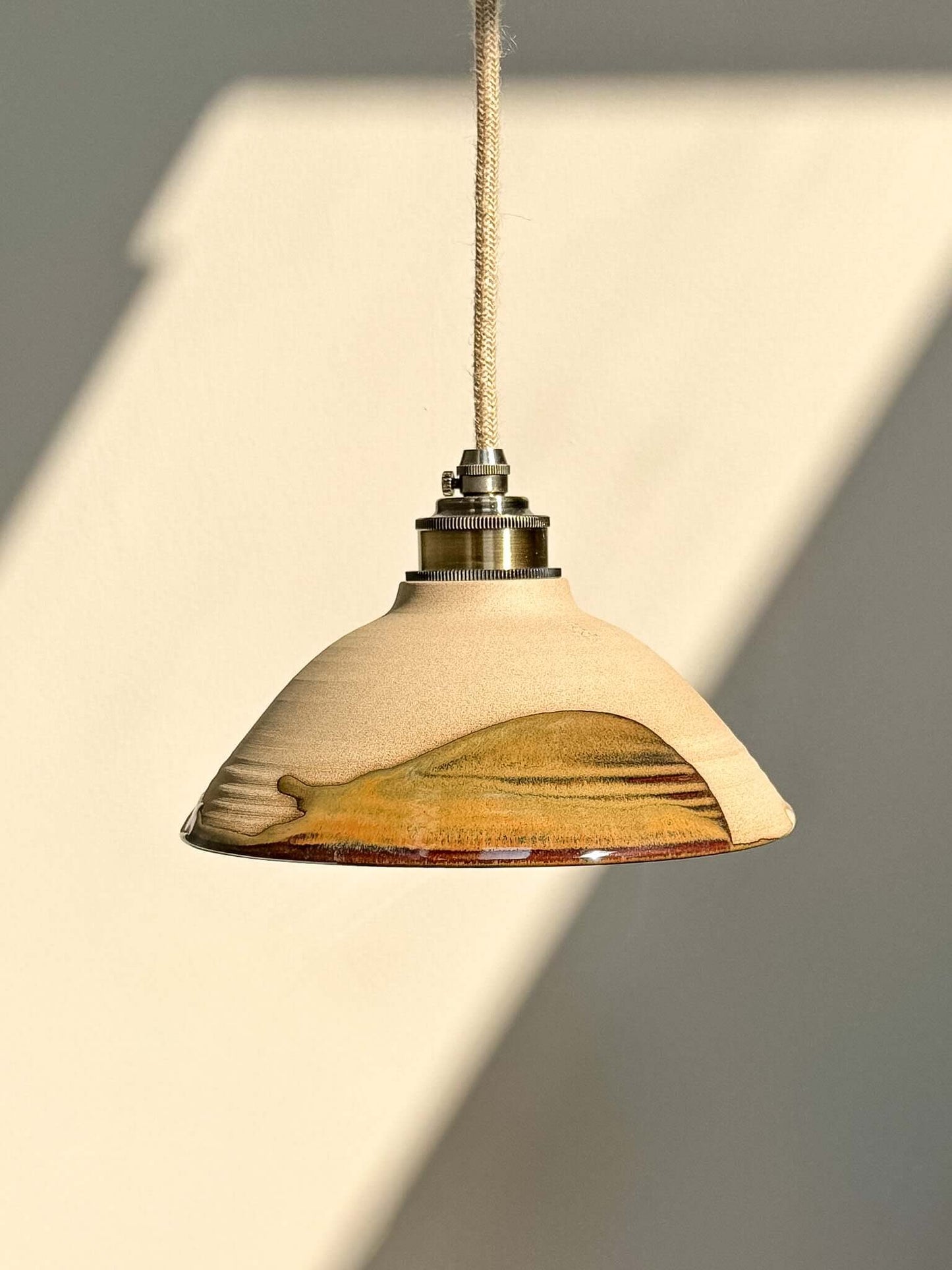 Ceramic Lamp Shade – Inyo #03 with bronze, amber, and deep blue glaze, showcasing natural textures and elegant design.