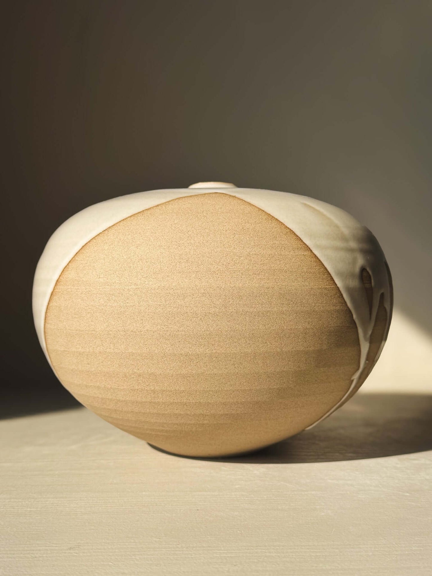 Orb Vase – #19 with smooth, rounded clay form and unique glaze patterns creating a calm, sculptural presence.