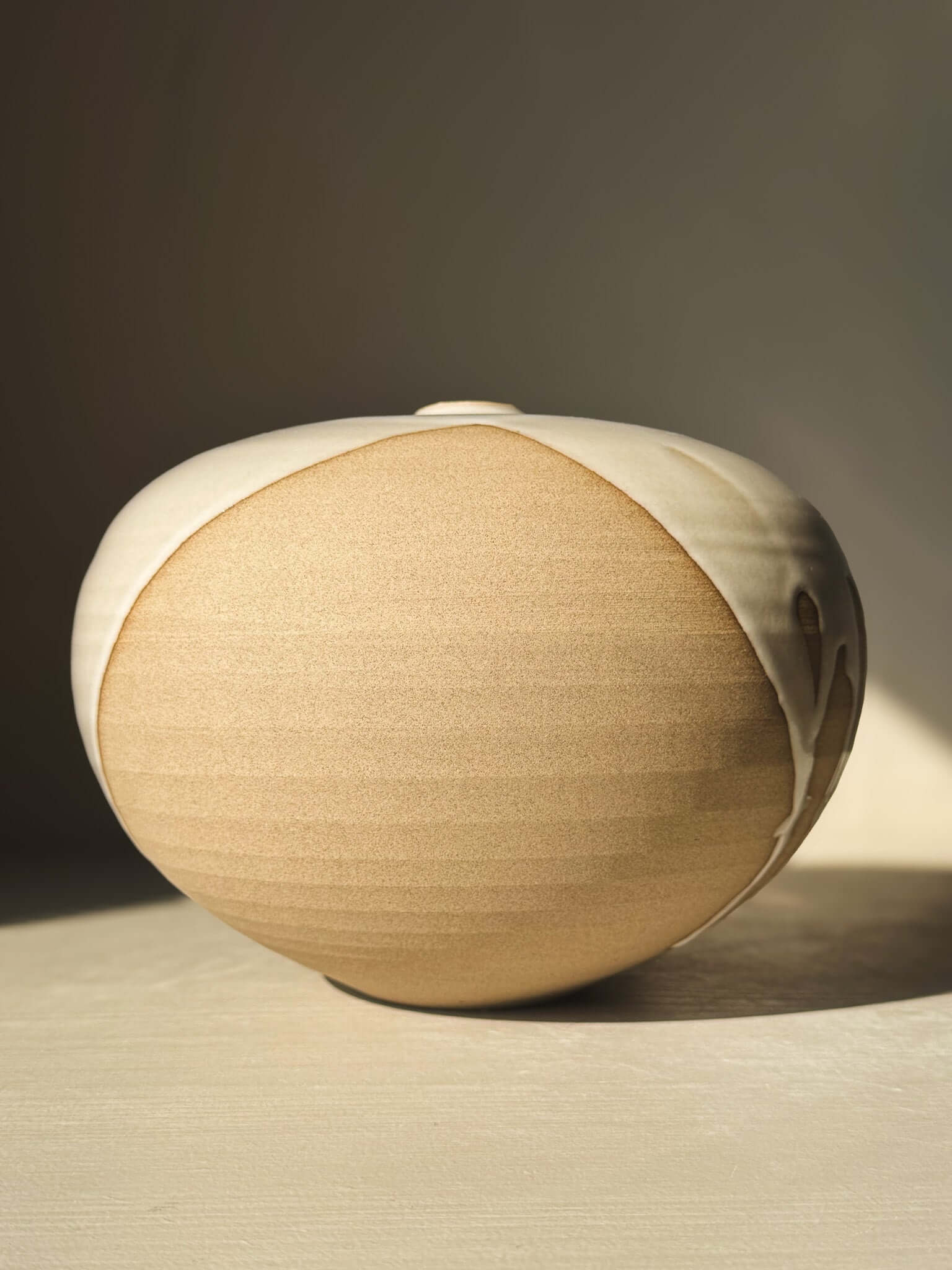 Orb Vase – #19 with smooth, rounded clay form and unique glaze patterns creating a calm, sculptural presence.