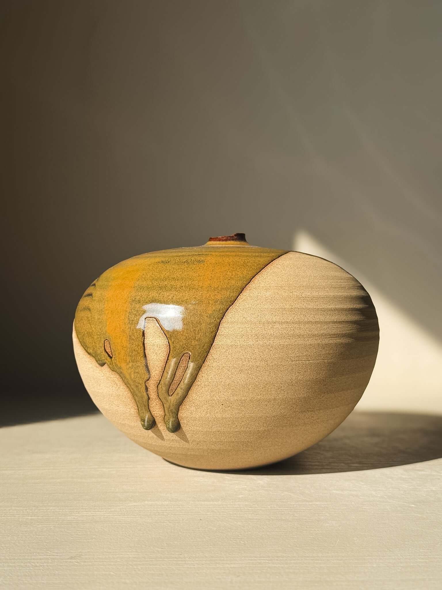 Orb Vase – #18 with unique glaze drips and organic patterns, showcasing a calm, sculptural presence on a neutral background.
